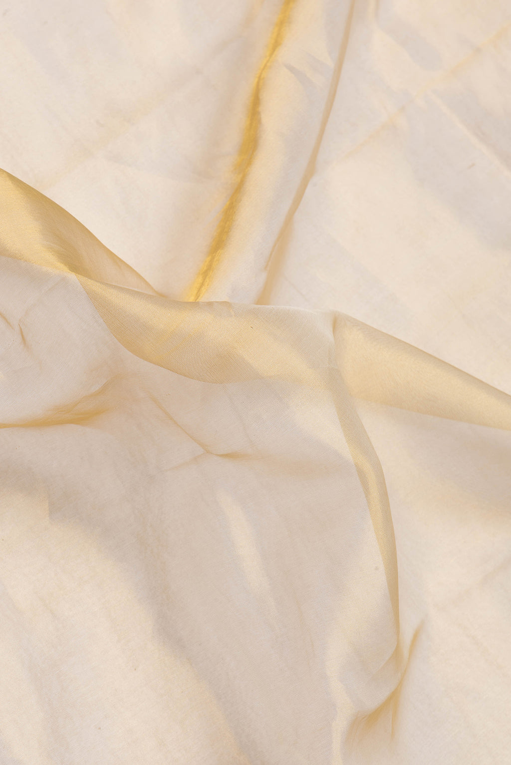 Close up of Gold Dual Tone Organza Silk Saree with Stripes on the body and Plain Border.  displaying folds