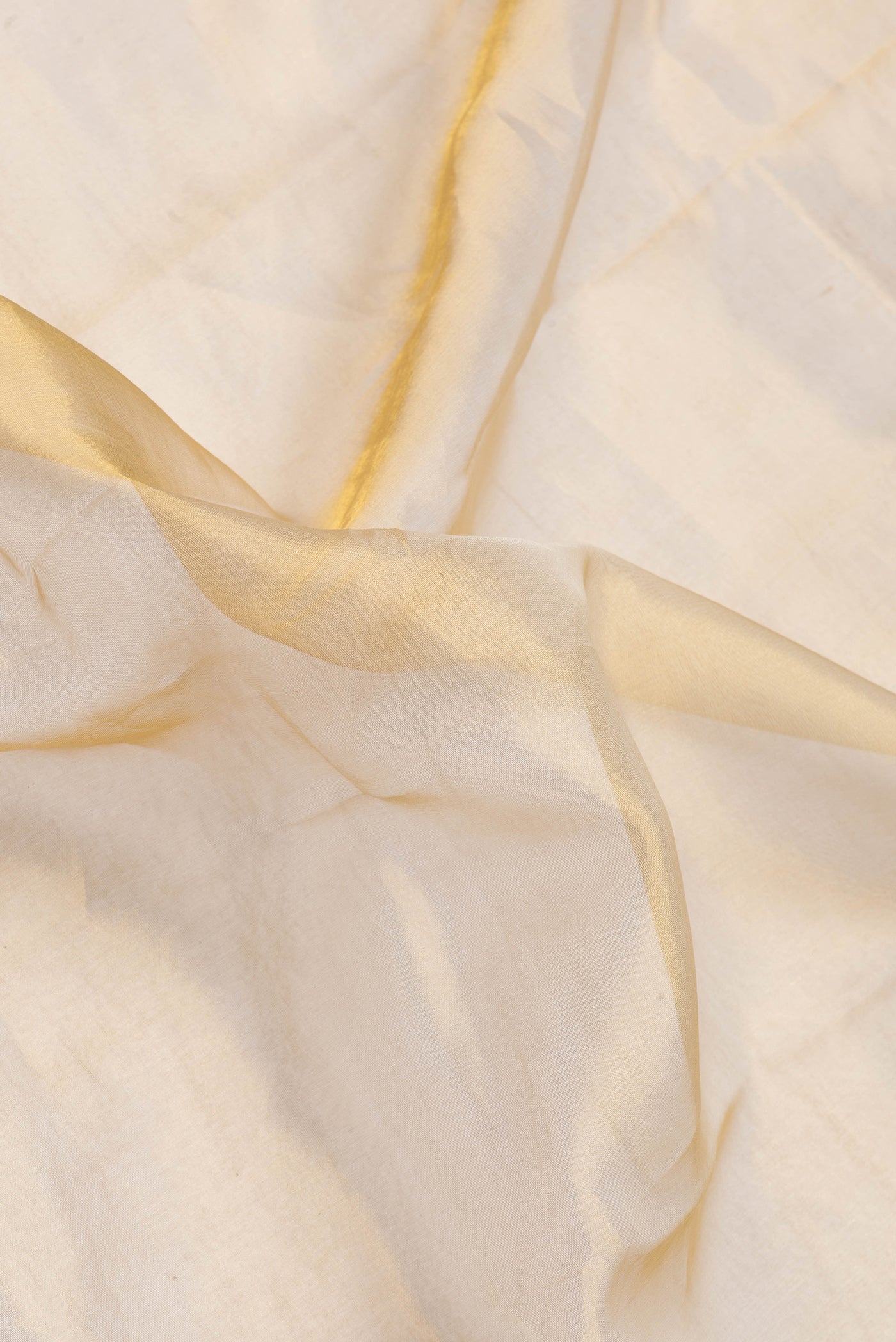 Close up of Gold Dual Tone Organza Silk Saree with Stripes on the body and Plain Border.  displaying folds