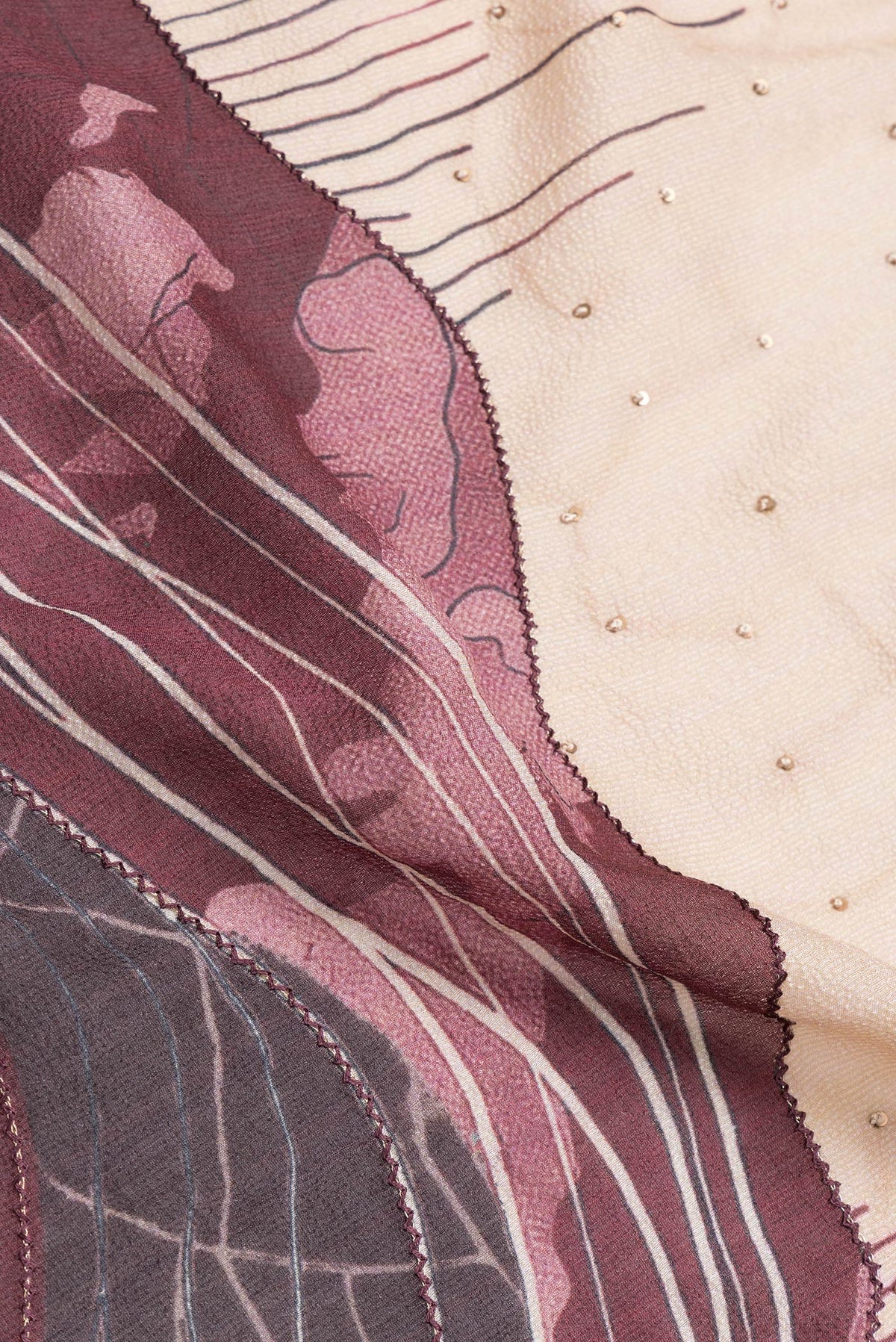 Close up of Maroon Dual Tone Tussar Silk Saree with Embroidery on the body and Embroidery Border.  displaying folds