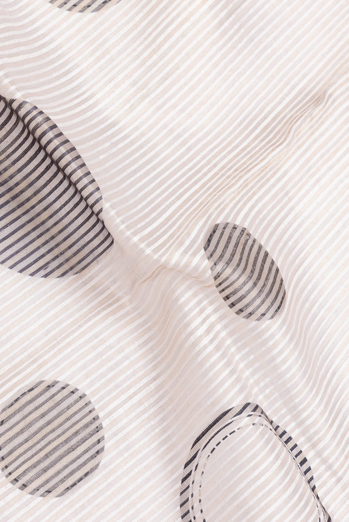 Close up of Beige Dual Tone Tussar Silk Saree with Stripes on the body and Plain Border.  displaying folds