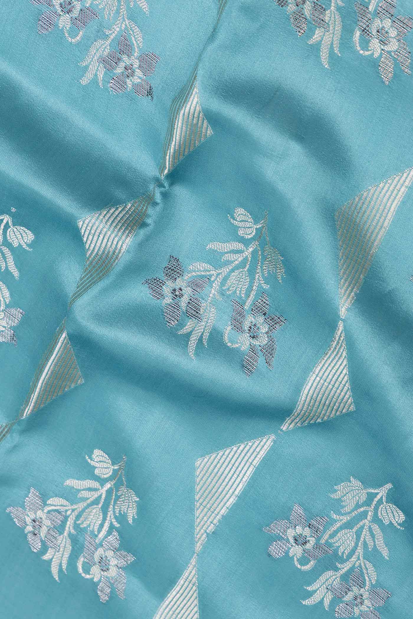 Close up of Light Blue Banarasi Raw Silk Saree with Zari Butta on the body and Zari Border displaying folds