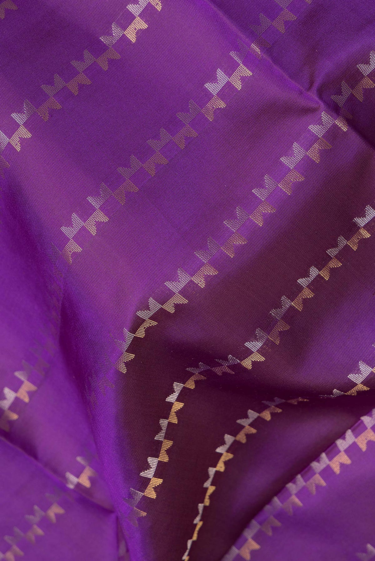 Close up of Pure Silk Purple Dual Tone Soft Saree with Zari Butta on the body and Zari Border.  displaying folds