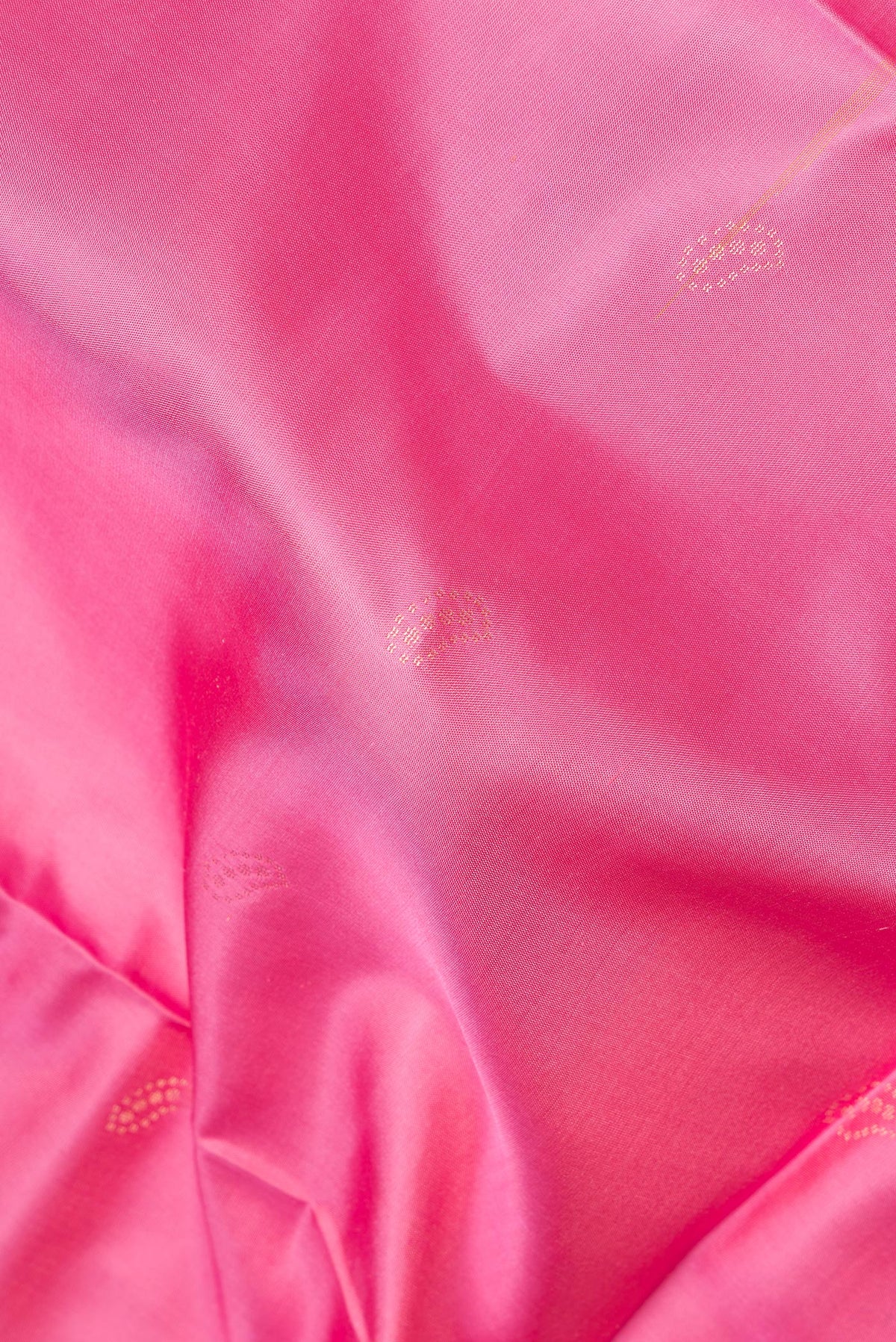 Close up of Pure Silk Pink Dual Tone Soft Saree with Zari Butta on the body and Fancy Border.  displaying folds