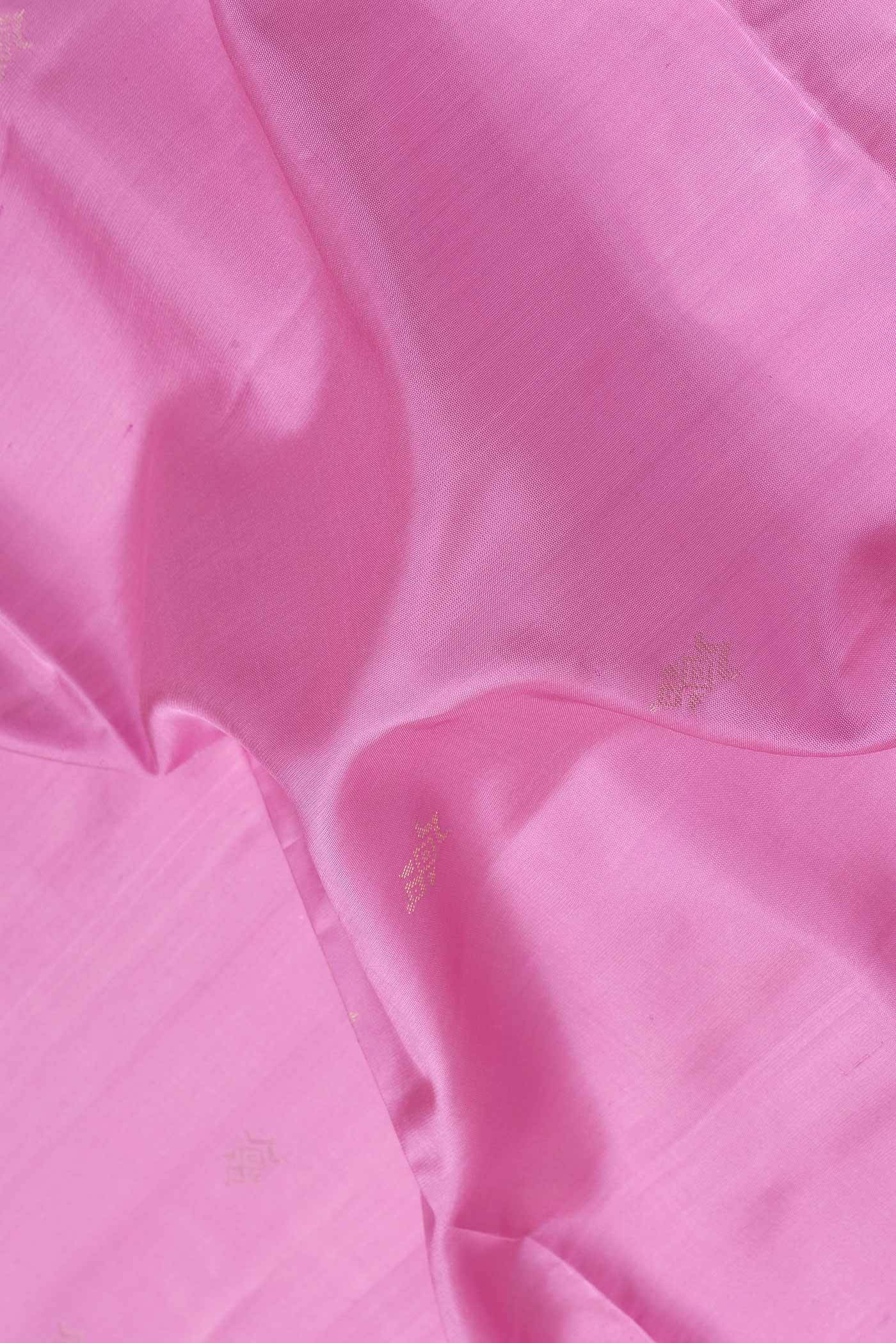 Close up of Pink Dual Tone Soft Silk Saree with Zari Butta on the body and Fancy Border.  displaying folds