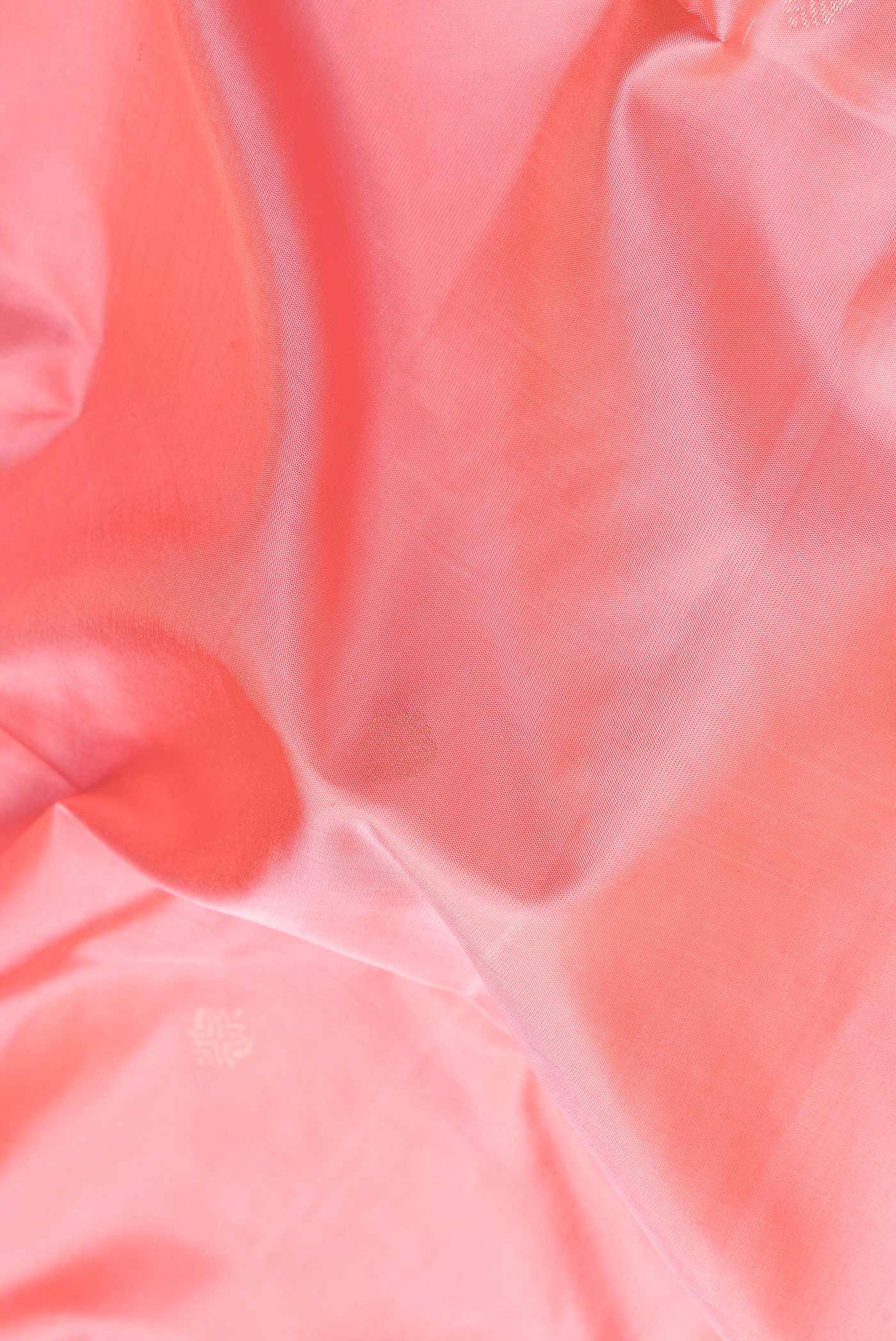 Close up of Pink Dual Tone Soft Silk Saree with Zari Butta on the body and Fancy Border.  displaying folds