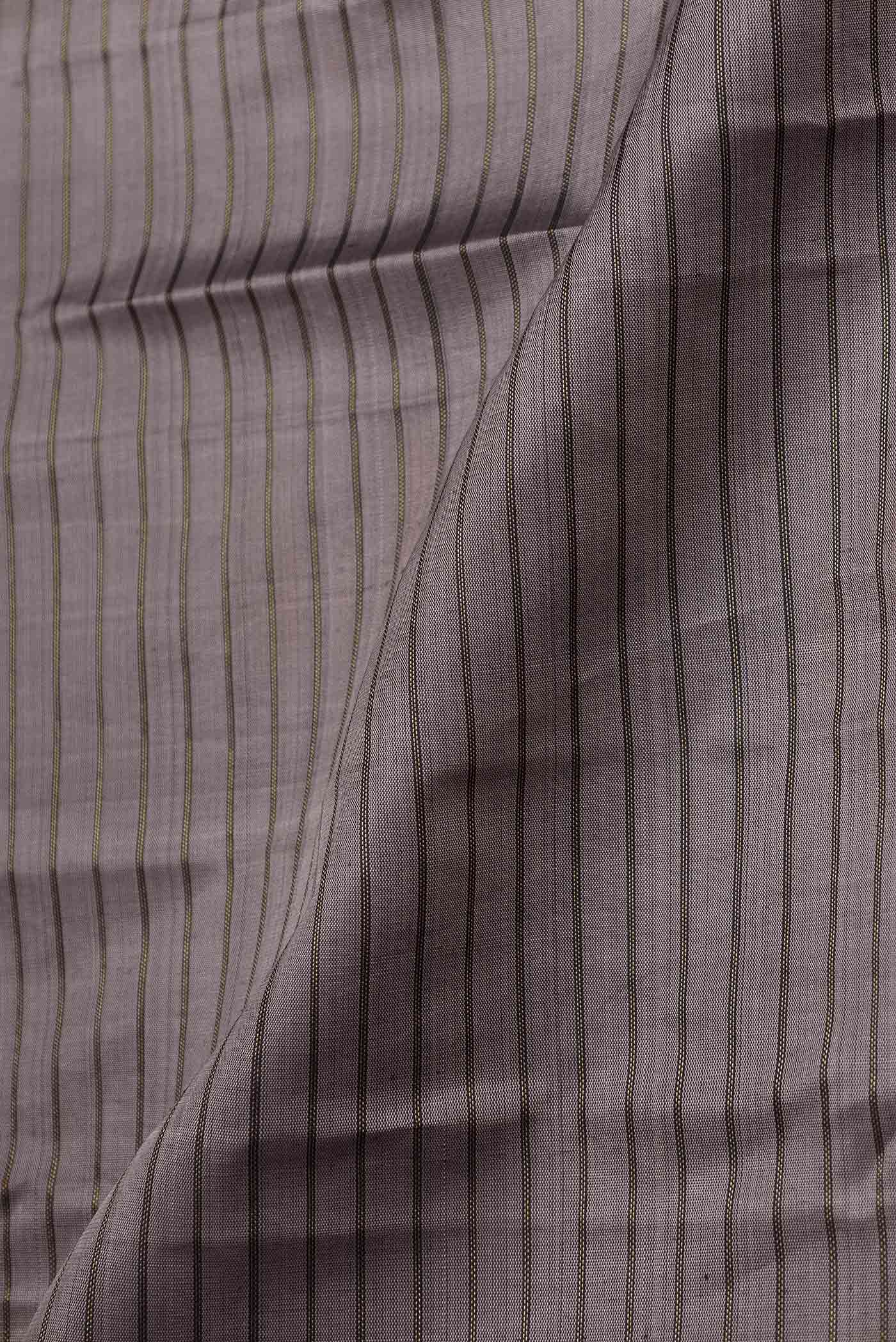 Close up of Grey Dual Tone Kanchipuram Silk Saree with Stripes on the body and Zari Border displaying folds