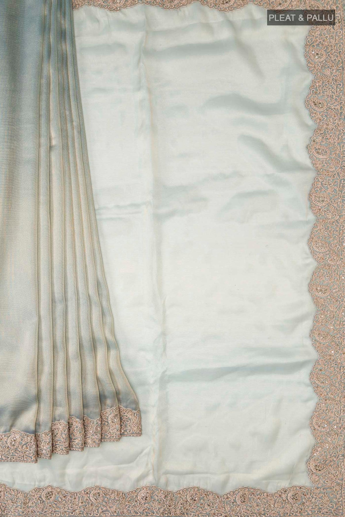 Pleats and pallu of Green Tissue Silk Saree with Plain Body and Embroidery Border