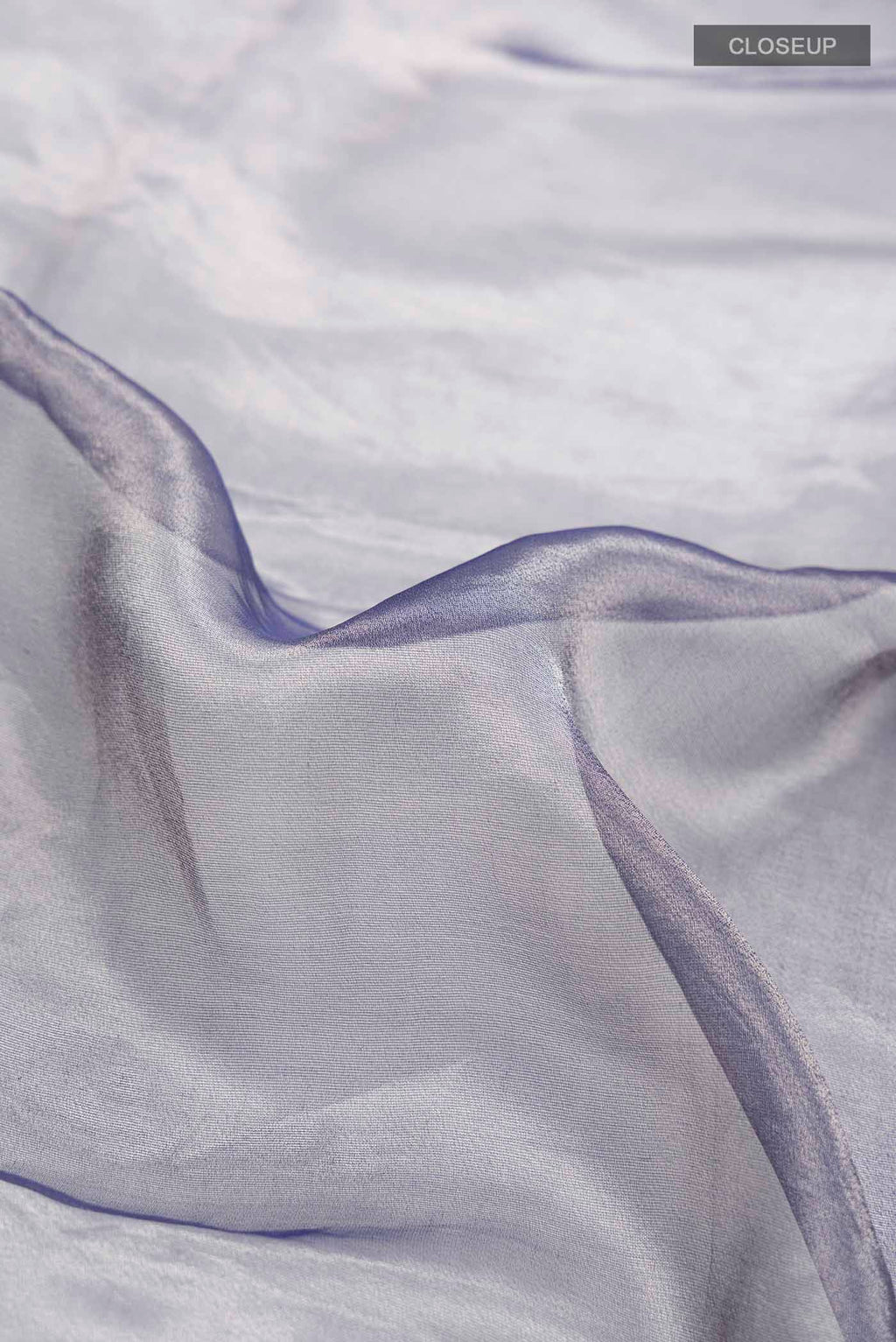 Close up of Lilac Tissue Silk Saree with Plain Body and Embroidery Border displaying folds