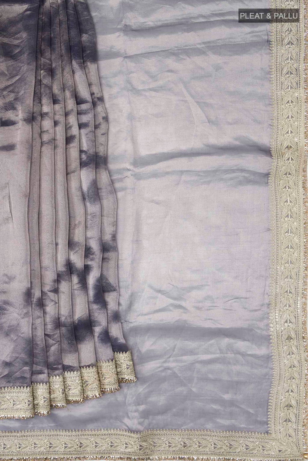 Pleats and pallu of Lilac Tissue Silk Saree with Plain Body and Embroidery Border