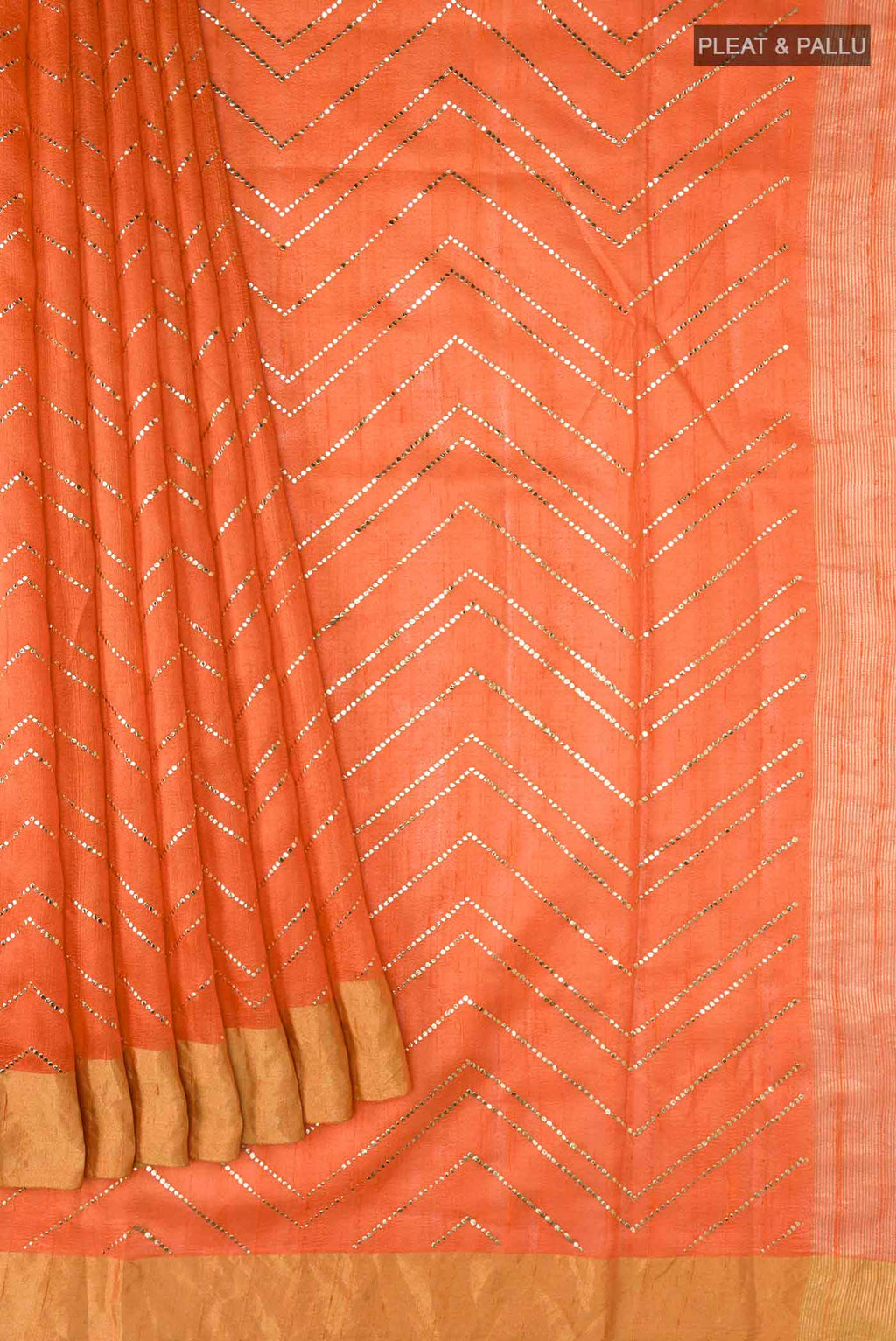 Pleats and pallu of Orange Raw Silk Saree with Embroidery on the body and Zari Border