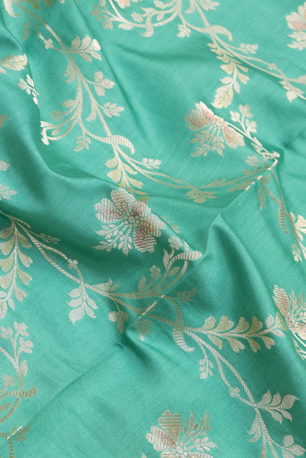 Close up of Sea Green Dual Tone Tussar Silk Saree with Zari Brocade on the body and Zari Border.  displaying folds