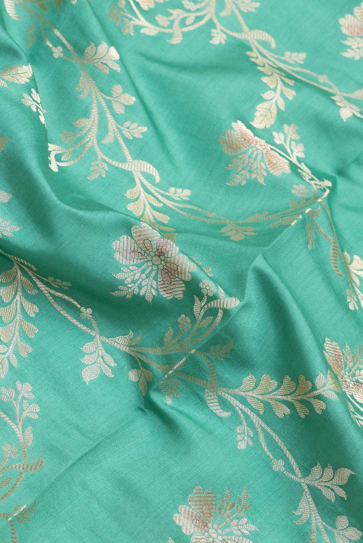 Close up of Sea Green Dual Tone Tussar Silk Saree with Zari Brocade on the body and Zari Border.  displaying folds