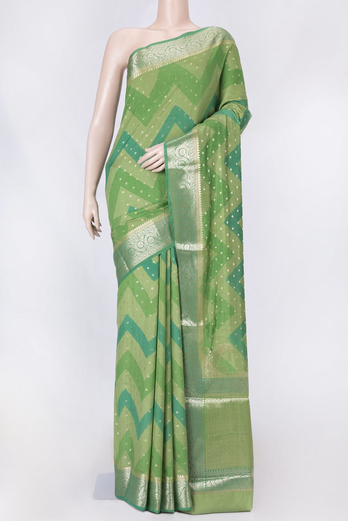 Green Dual Tone Tussar Silk Saree with Zari Butta on the body and Zari Border displayed on a mannequin