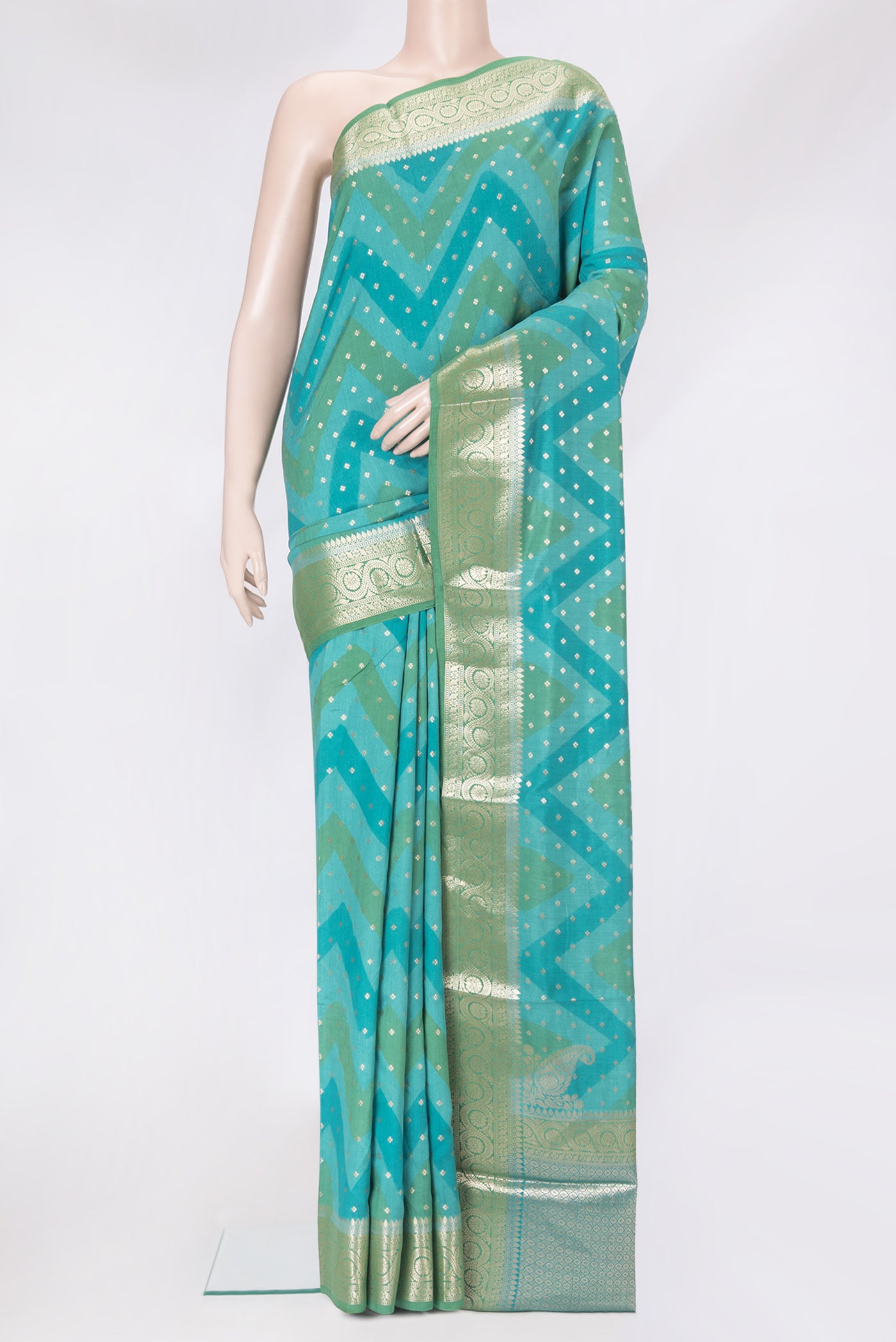 Peacock Blue Tussar Silk Saree with Zari Butta on the body and Zari Border.  displayed on a mannequin