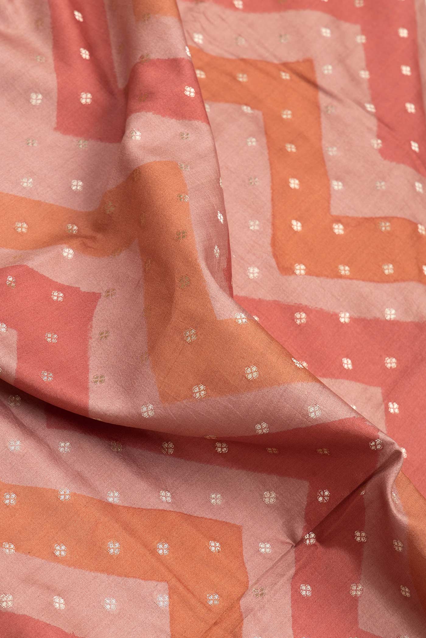 Close up of Brown Dual Tone Tussar Silk Saree with Zari Butta on the body and Zari Border.  displaying folds