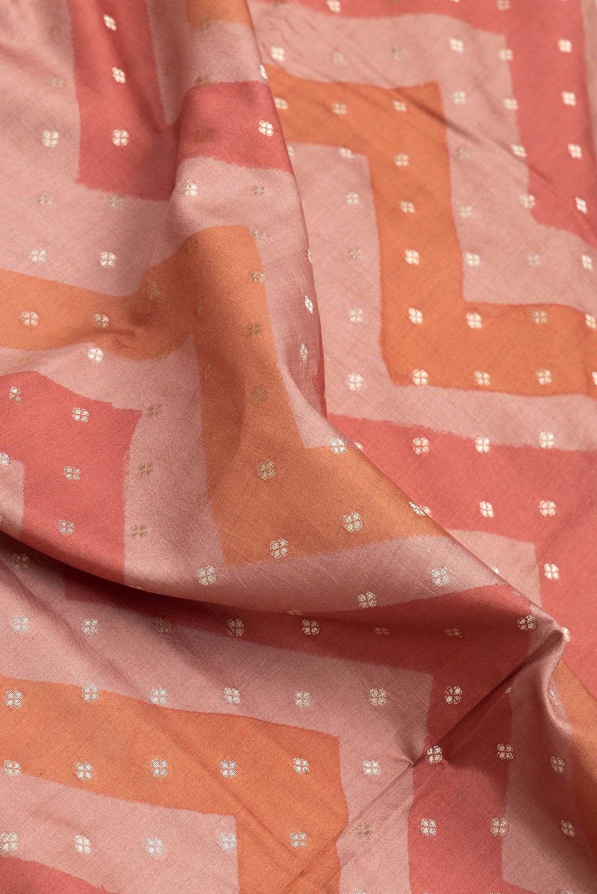 Close up of Brown Dual Tone Tussar Silk Saree with Zari Butta on the body and Zari Border.  displaying folds