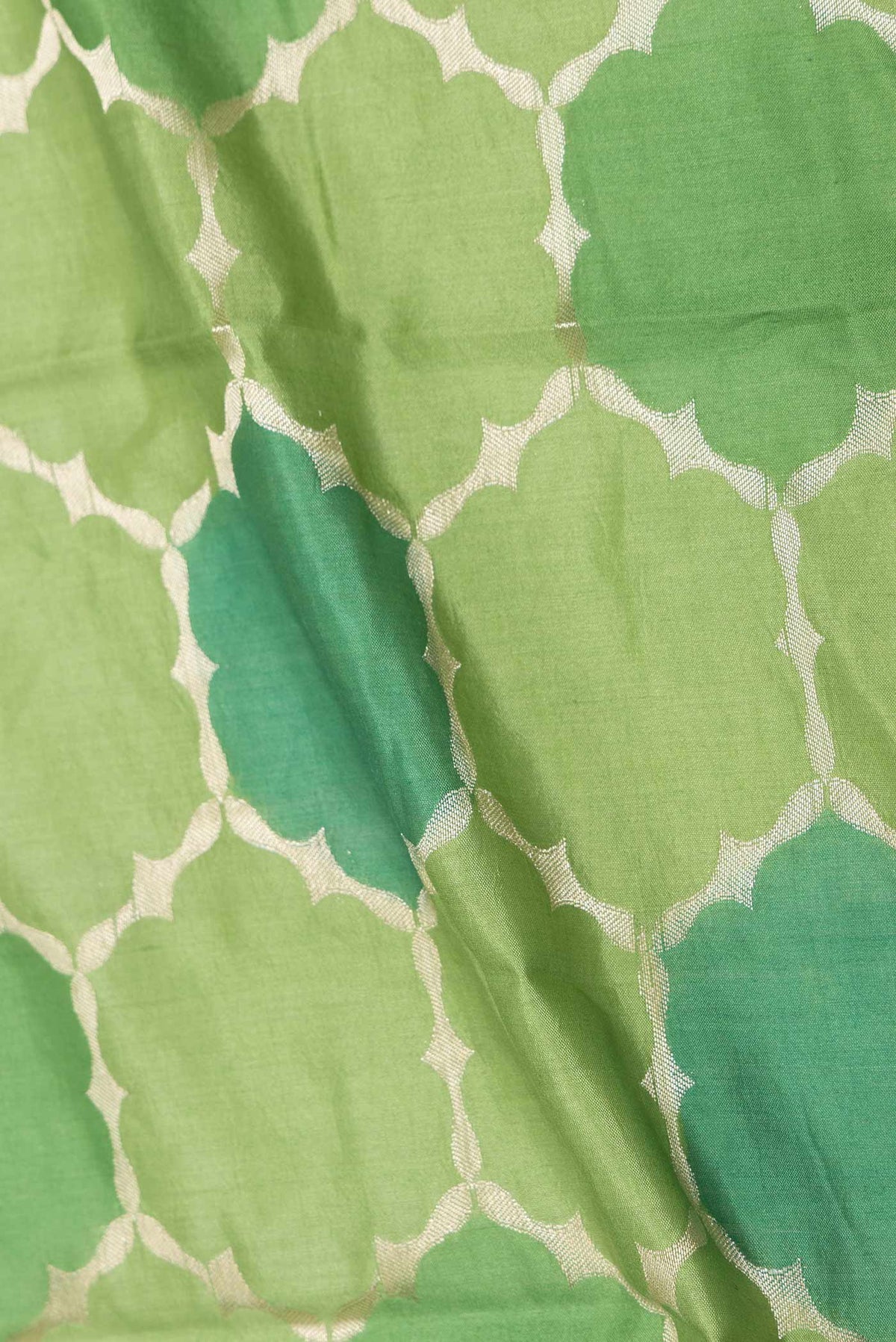 Close up of Green Banarasi Raw Silk Saree with Zari Brocade on the body and Zari Border displaying folds