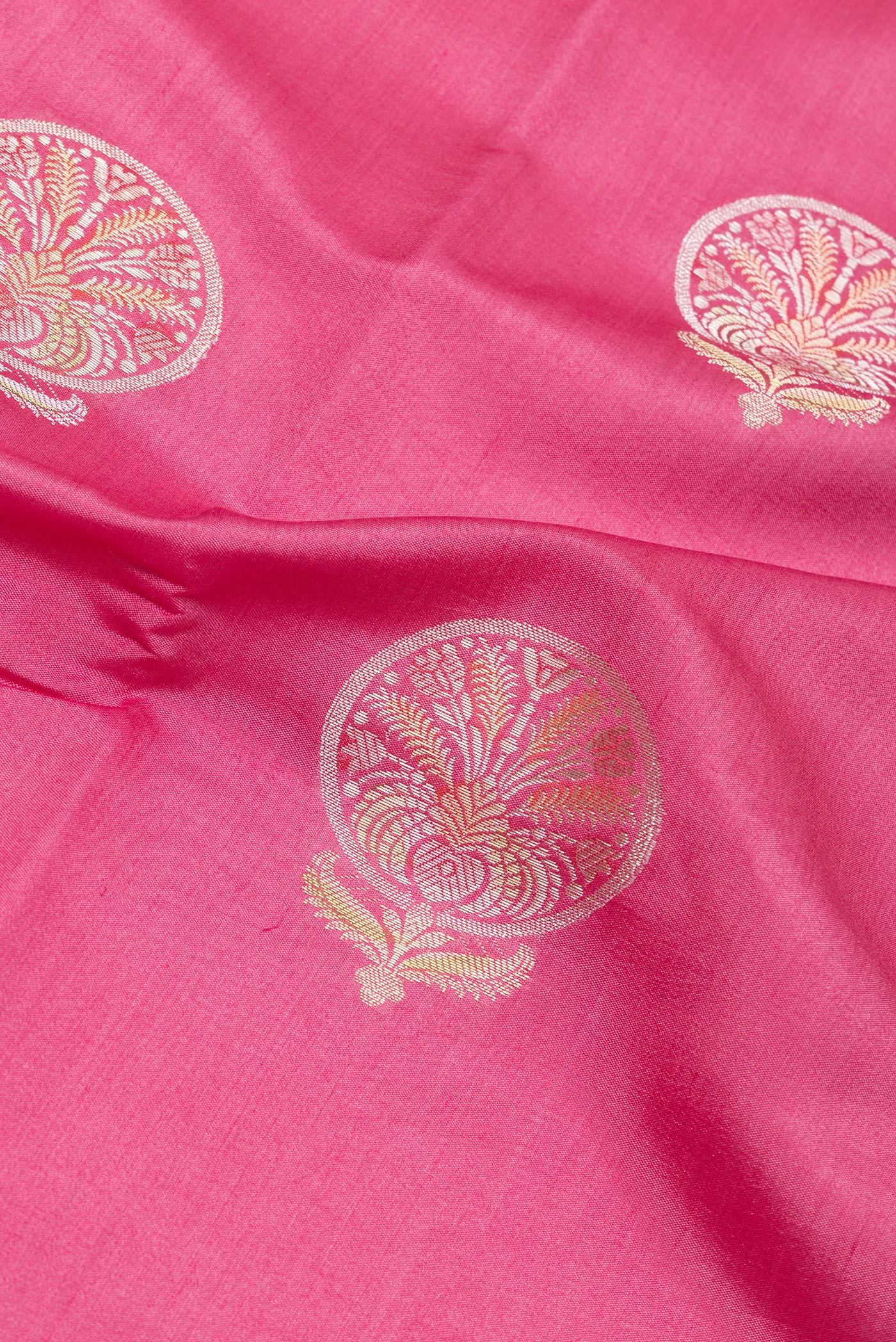 Close up of Pink Dual Tone Tussar Silk Saree with Zari Butta on the body and Zari Border.  displaying folds