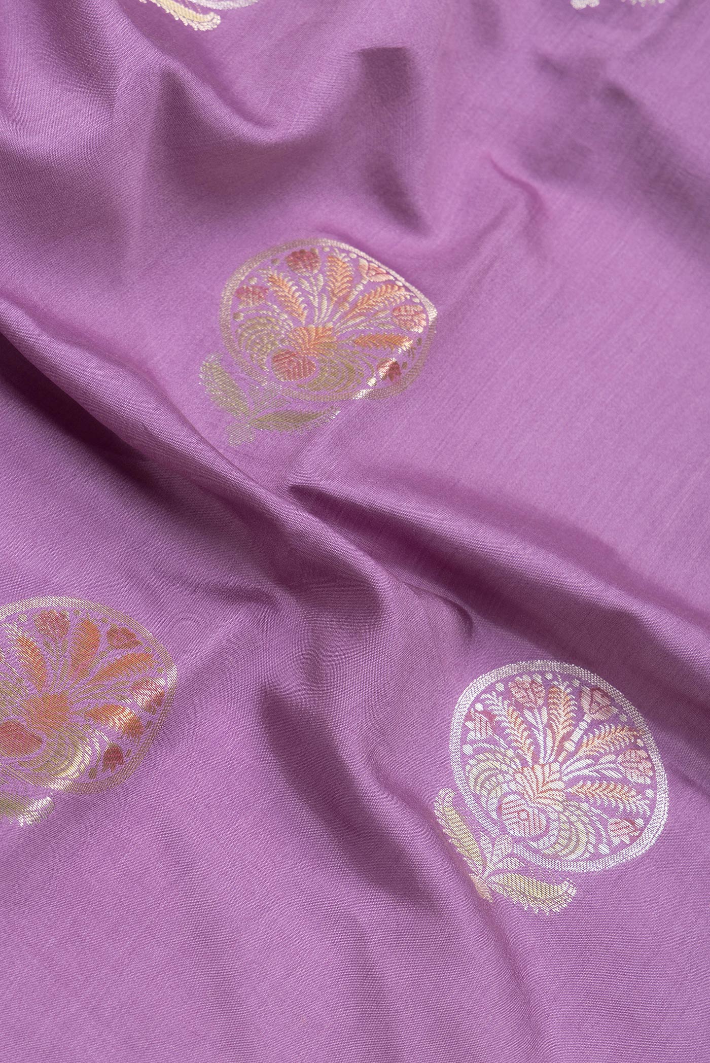 Close up of Lavender Dual Tone Tussar Silk Saree with Zari Butta on the body and Zari Border.  displaying folds