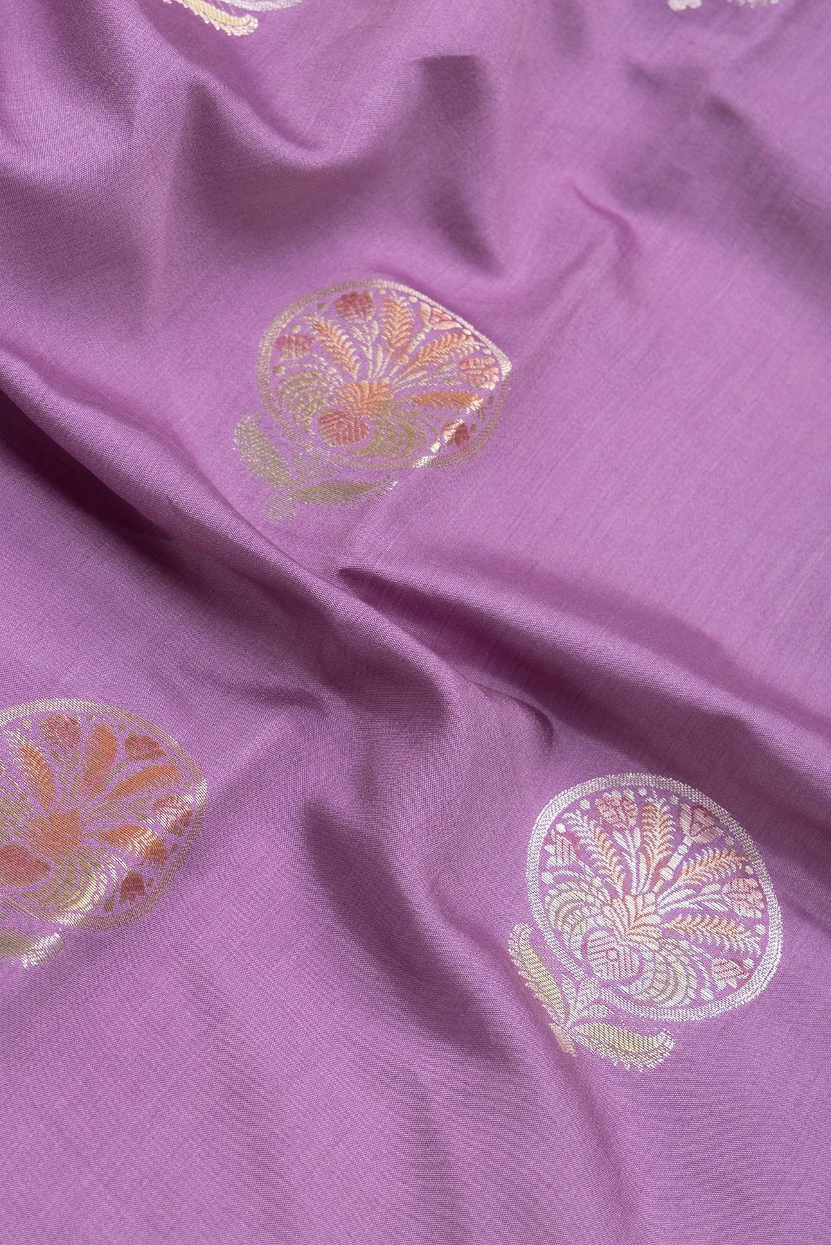 Close up of Lavender Dual Tone Tussar Silk Saree with Zari Butta on the body and Zari Border.  displaying folds