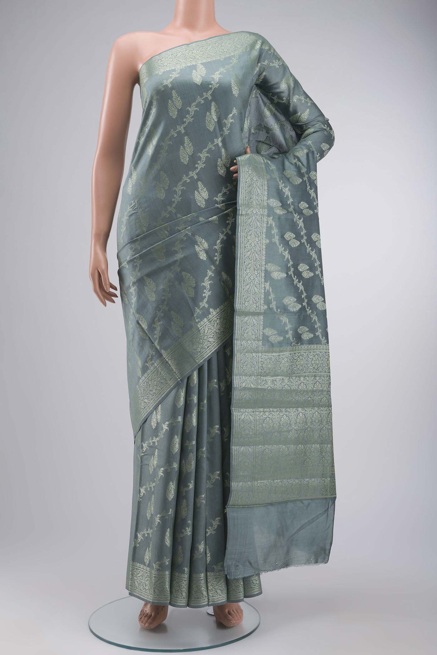 Green Banarasi Raw Silk Saree with Zari Butta on the body and Zari Border displayed on a mannequin