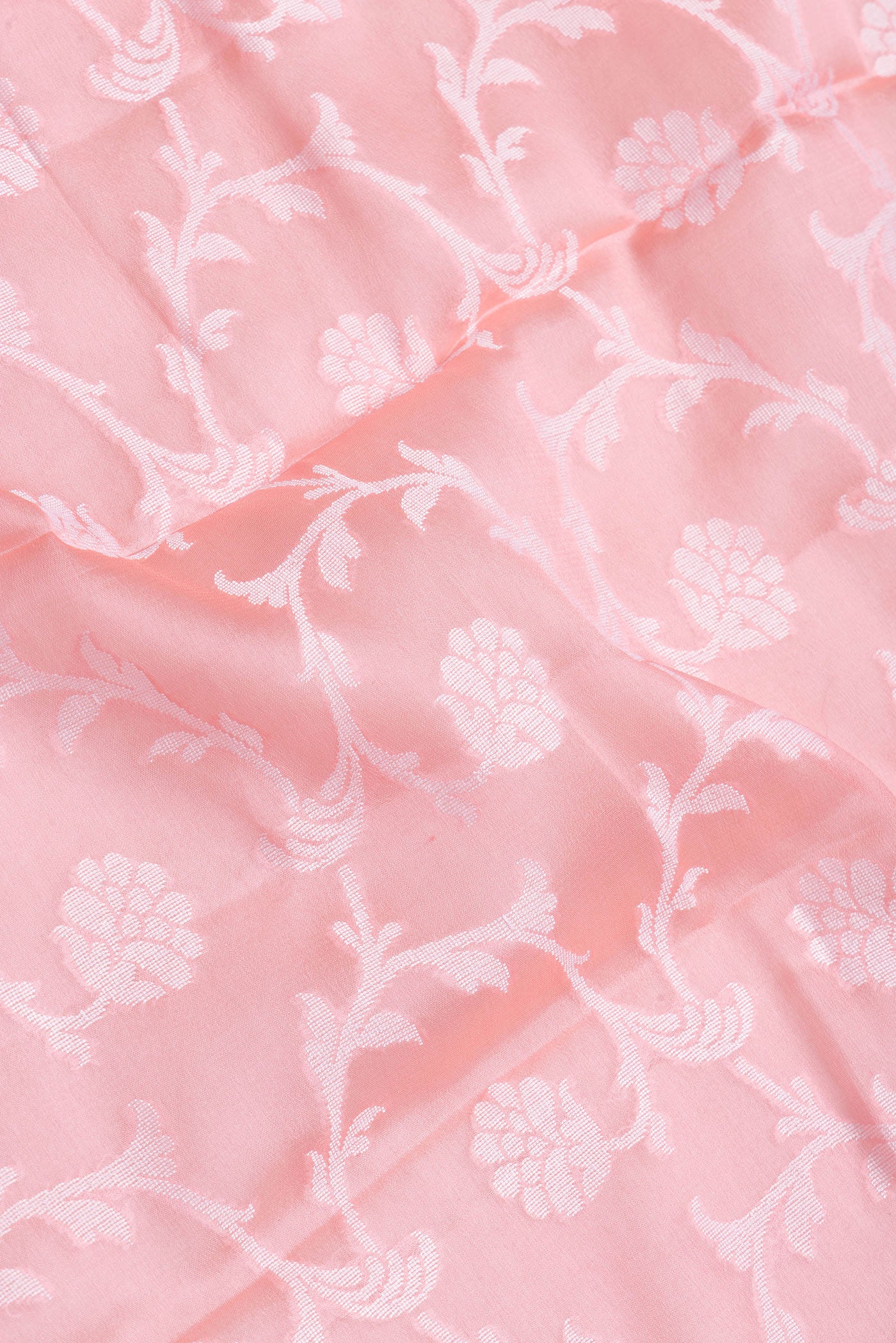Close up of Pink Dual Tone Mysore Georgette Saree with Zari Brocade on the body and Thread Border.  displaying folds