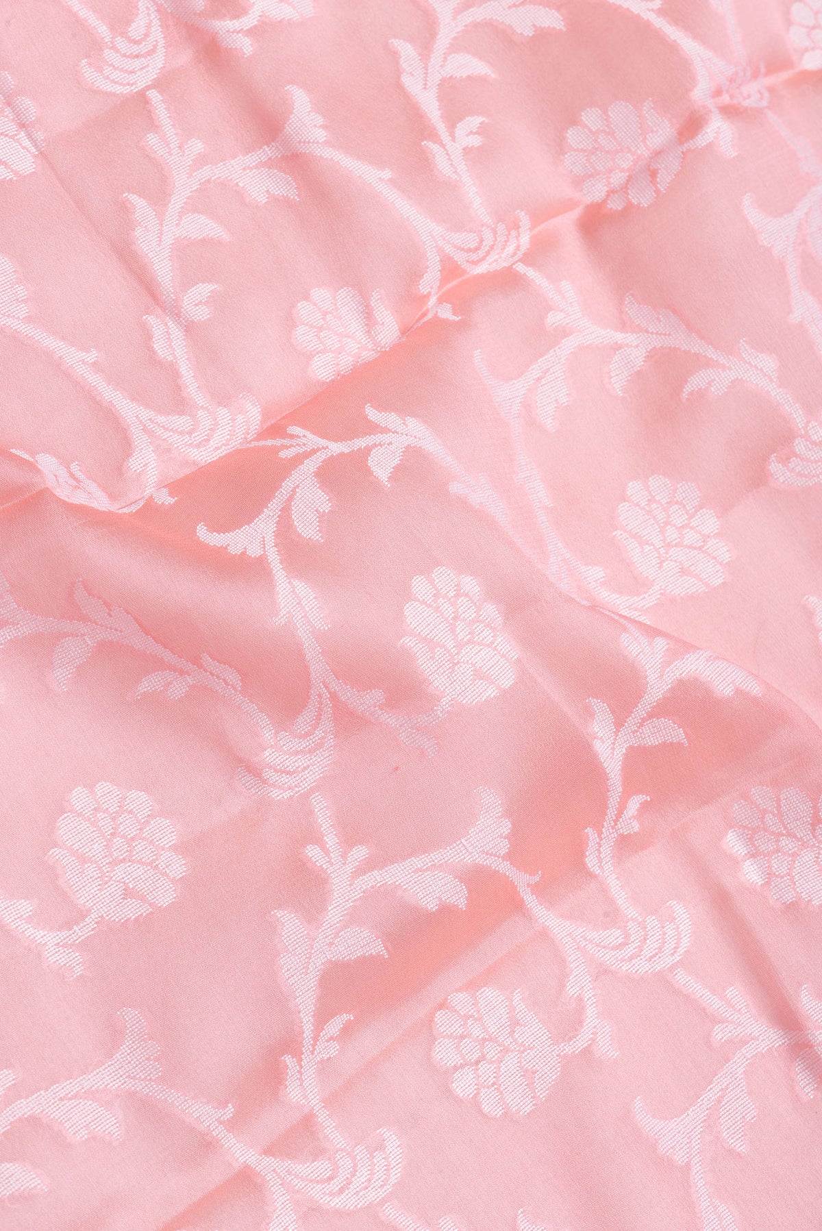 Close up of Pink Dual Tone Mysore Georgette Saree with Zari Brocade on the body and Thread Border.  displaying folds
