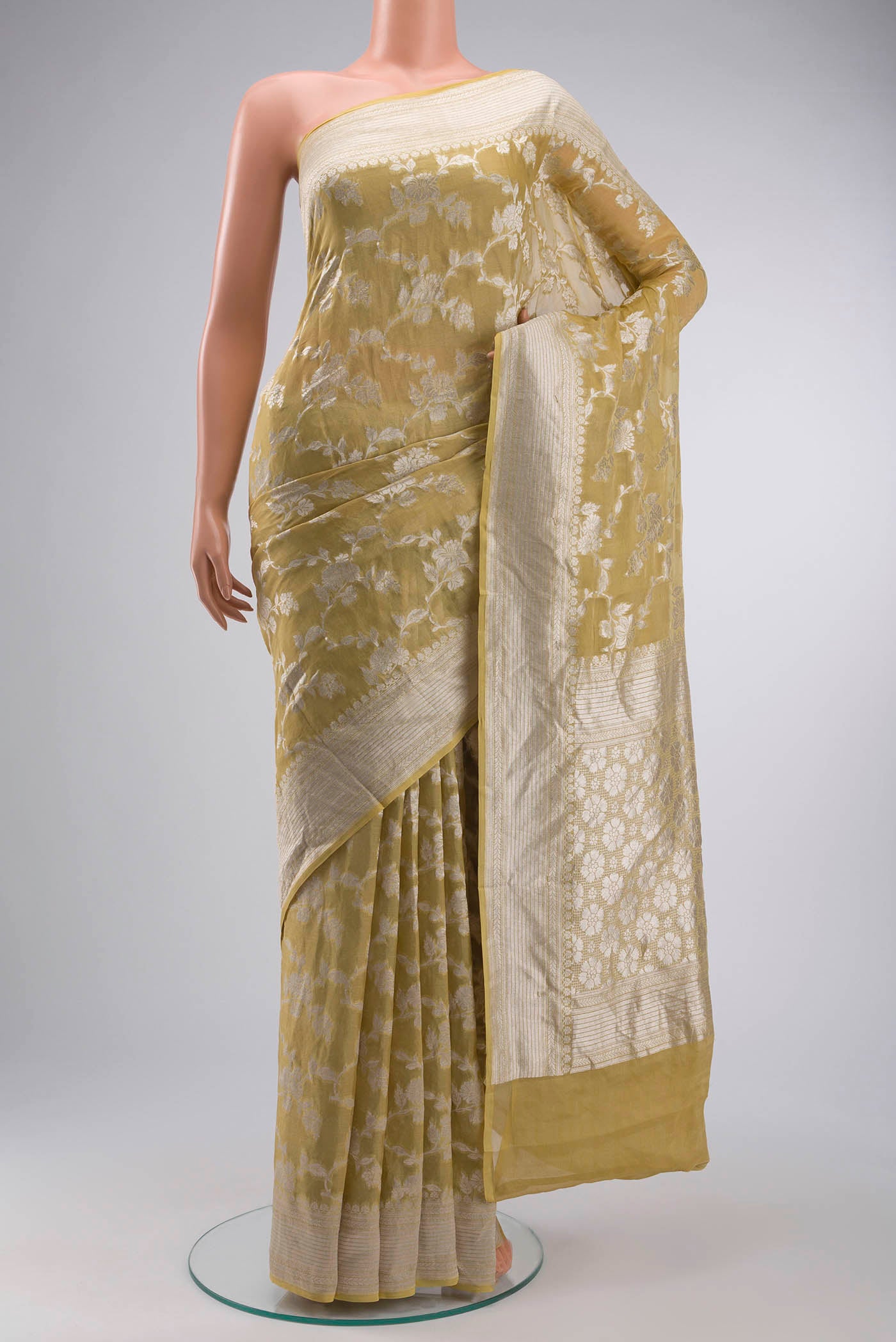 Beige Banarasi Georgette Saree with Zari Butta on the body and Zari Border displayed on a mannequin