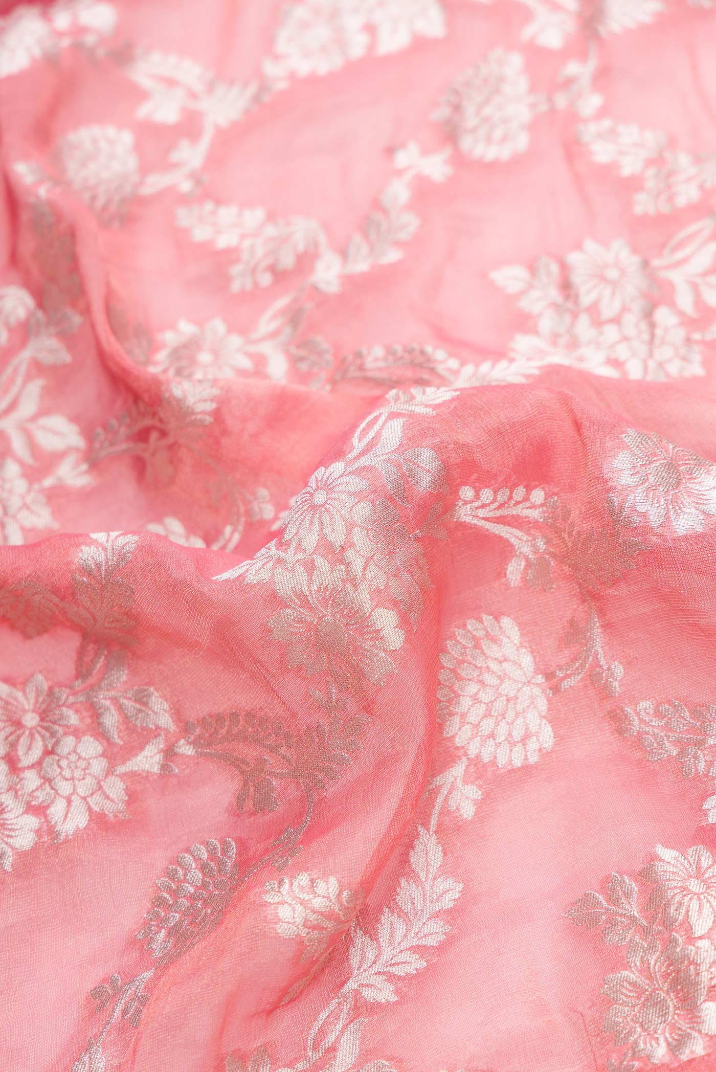 Close up of Pink Dual Tone Banarasi Georgette Saree with Zari Brocade on the body and Zari Border.  displaying folds