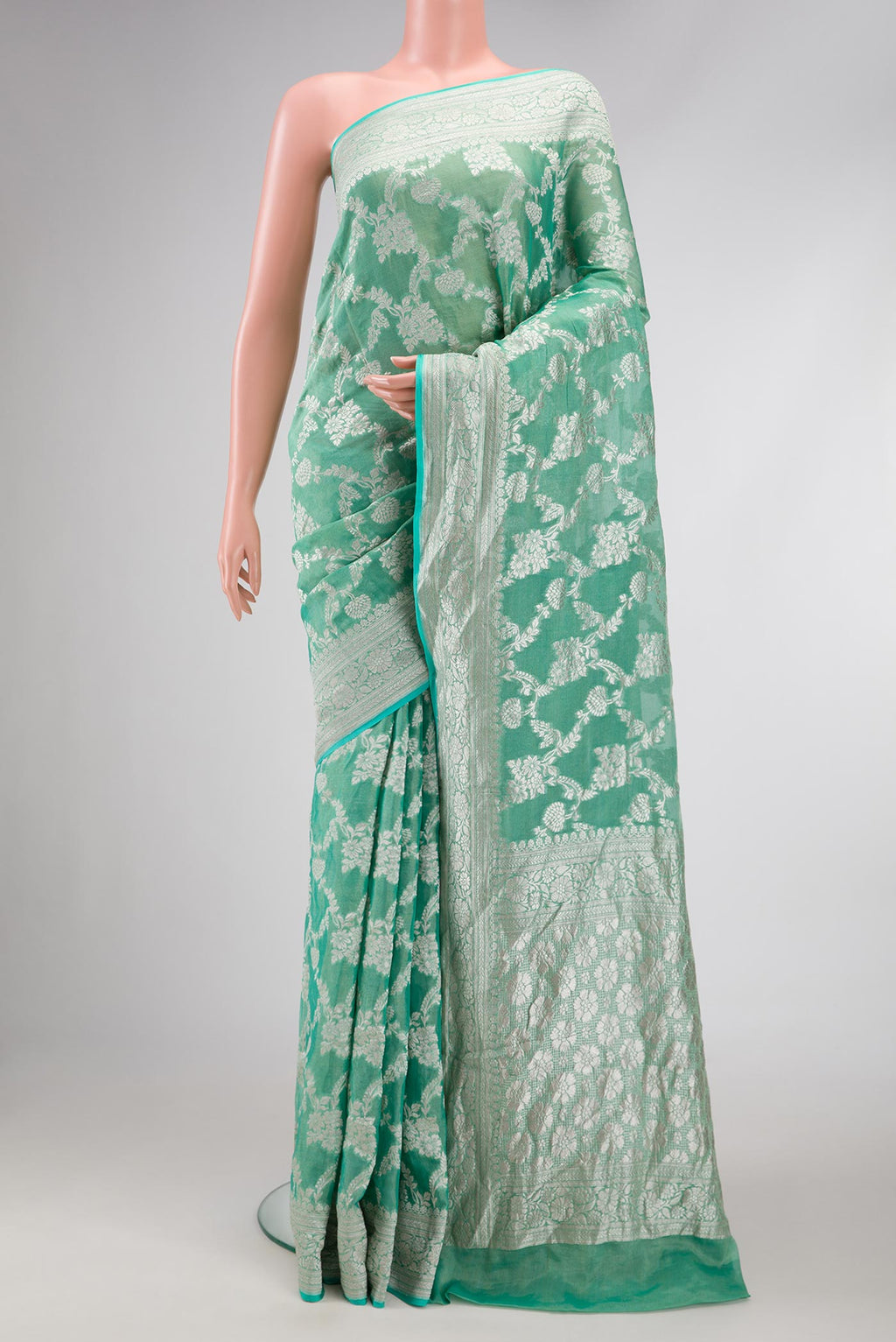 Green Dual Tone Banarasi Georgette Saree with Zari Brocade on the body and Zari Border.  displayed on a mannequin