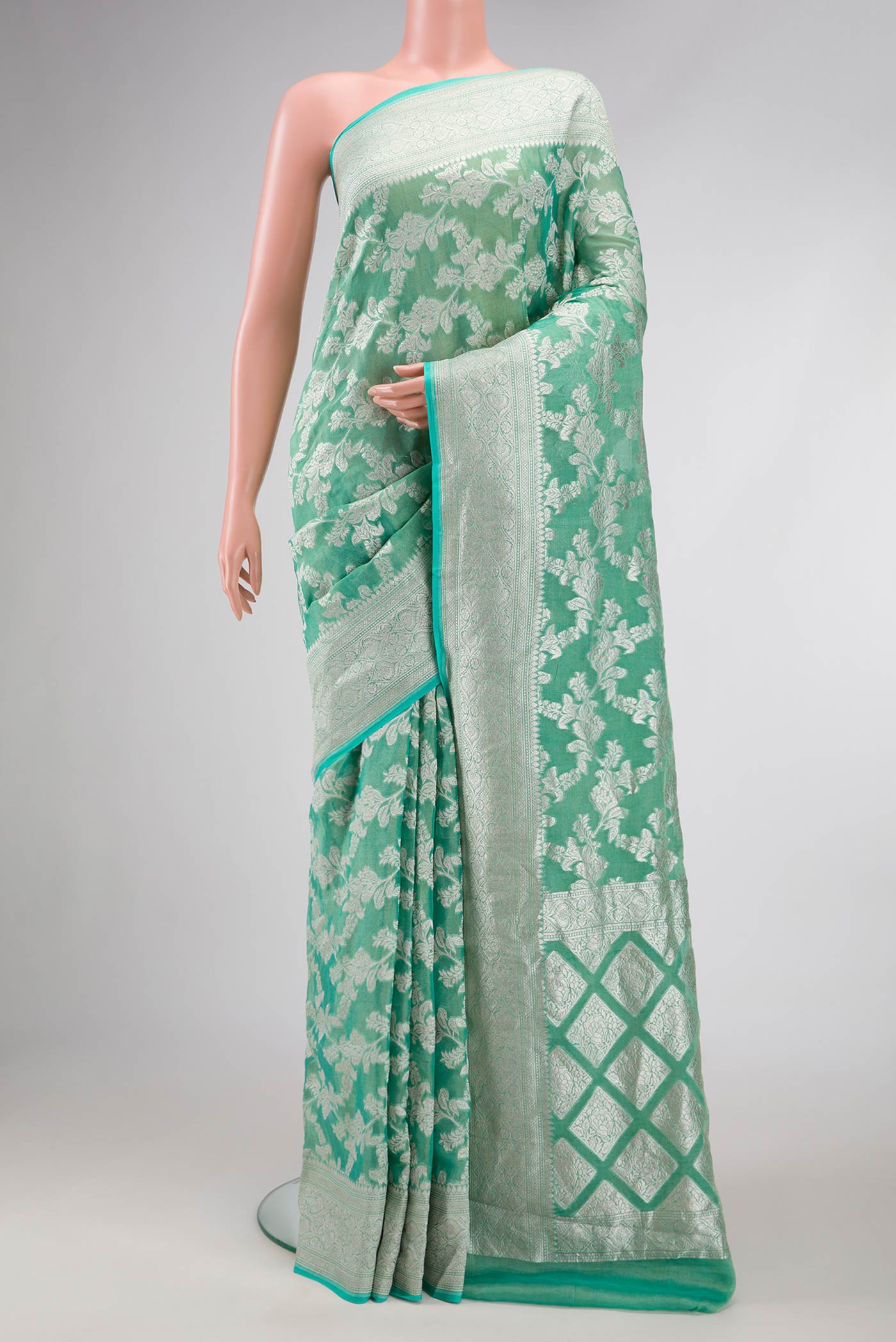 Green Dual Tone Banarasi Georgette Saree with Zari Brocade on the body and Zari Border.  displayed on a mannequin