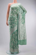 Green Banarasi Georgette Saree with Zari Butta on the body and Zari Border displayed on a mannequin