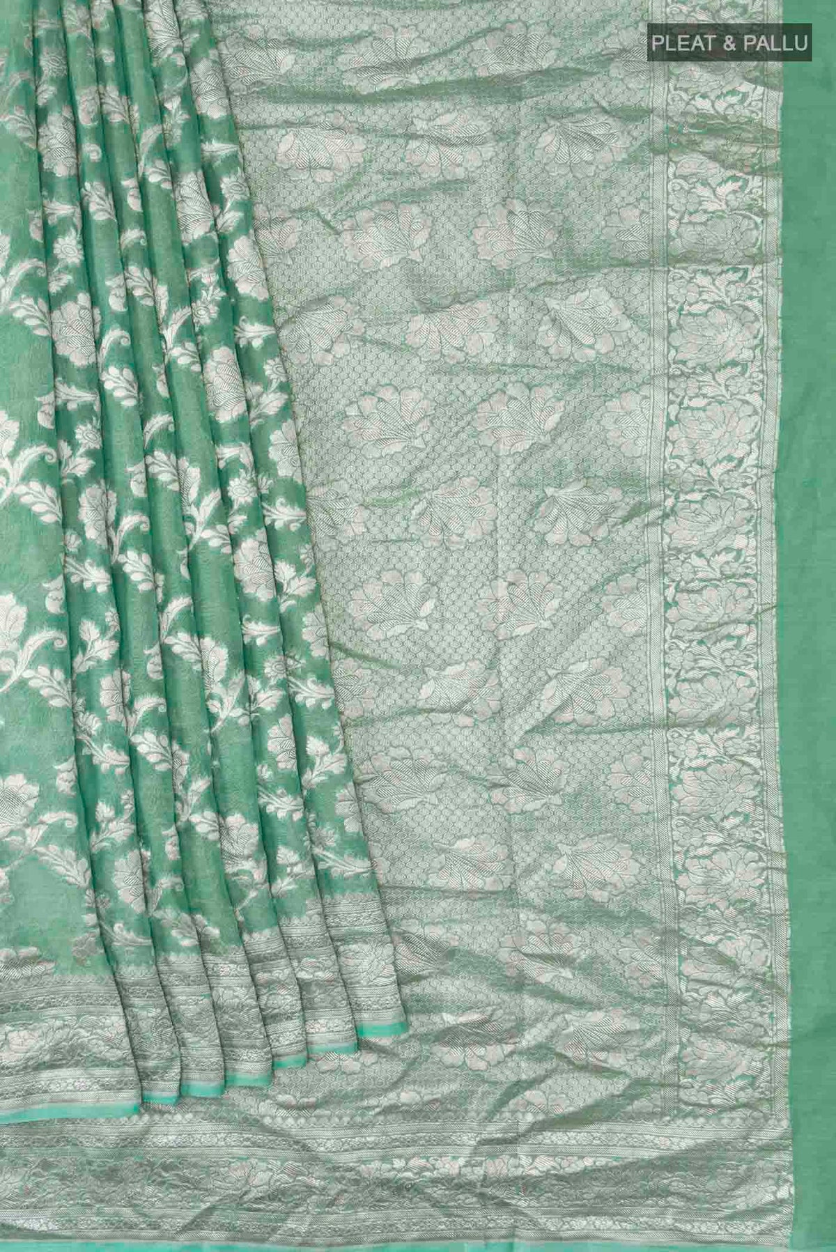 Pleats and pallu of Green Banarasi Georgette Saree with Zari Butta on the body and Zari Border
