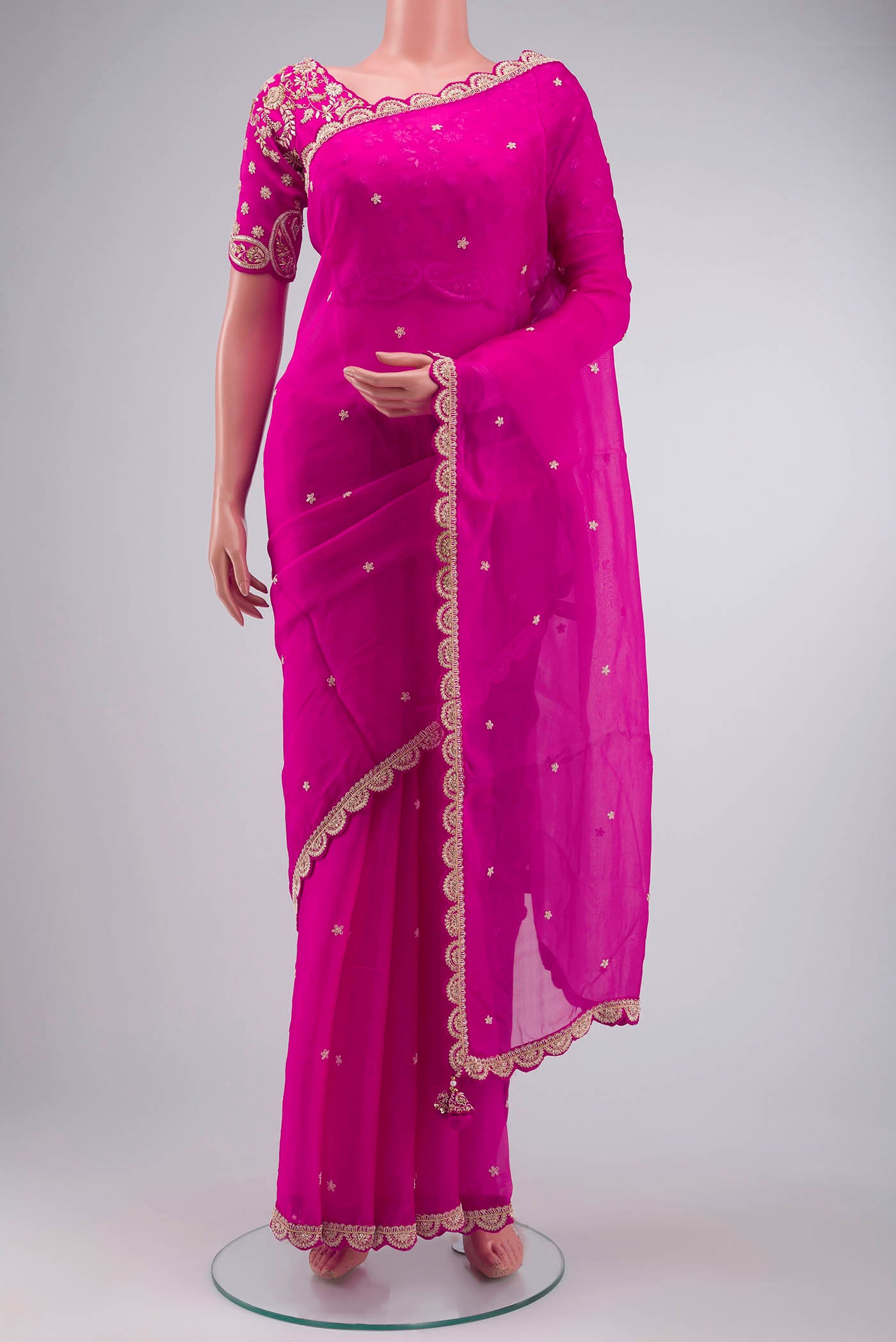 Pink Organza Silk Saree with Embroidery on the body and Embroidery Border displayed on a mannequin