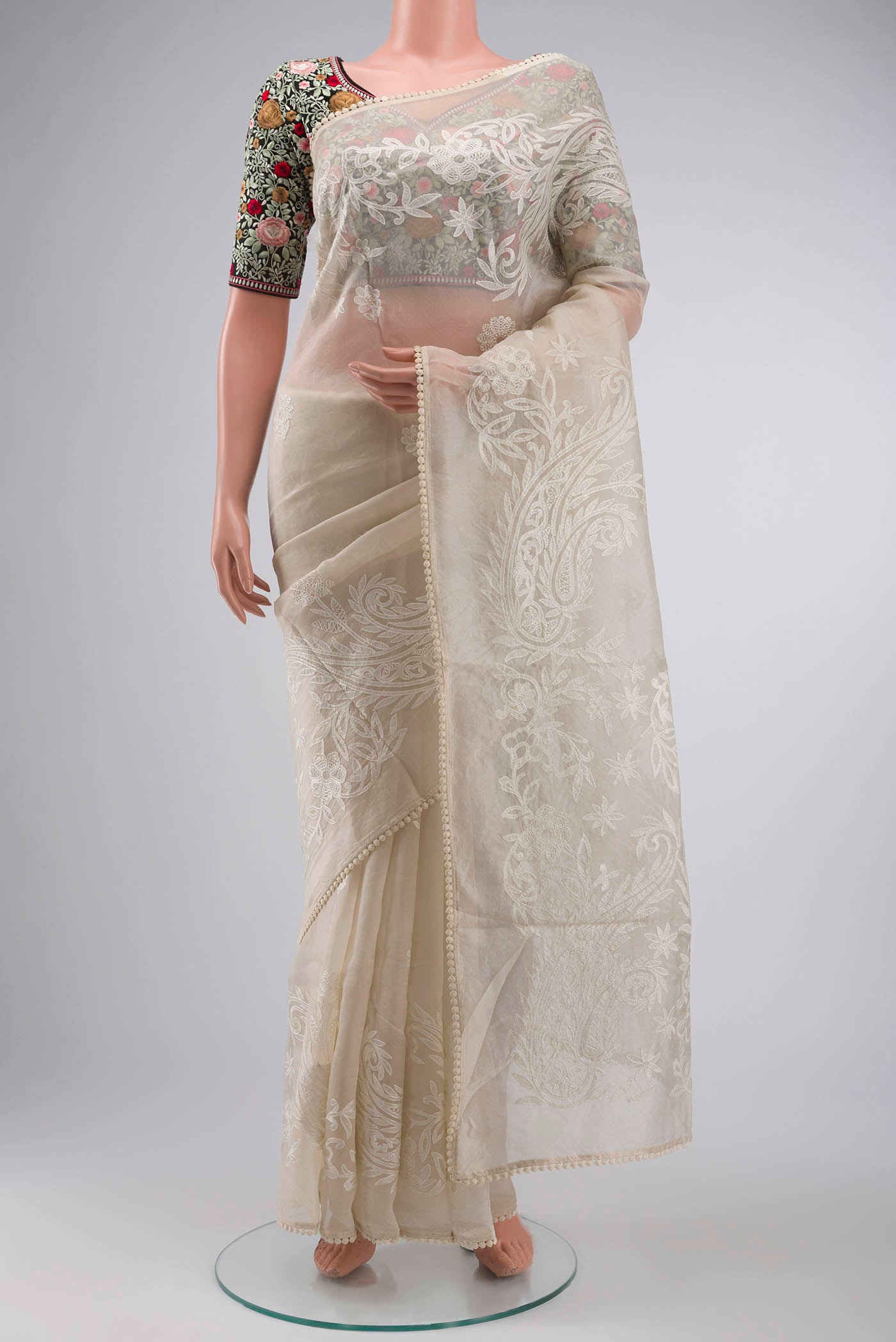 Off White Organza Silk Saree with Embroidery on the body and Embroidery Border displayed on a mannequin