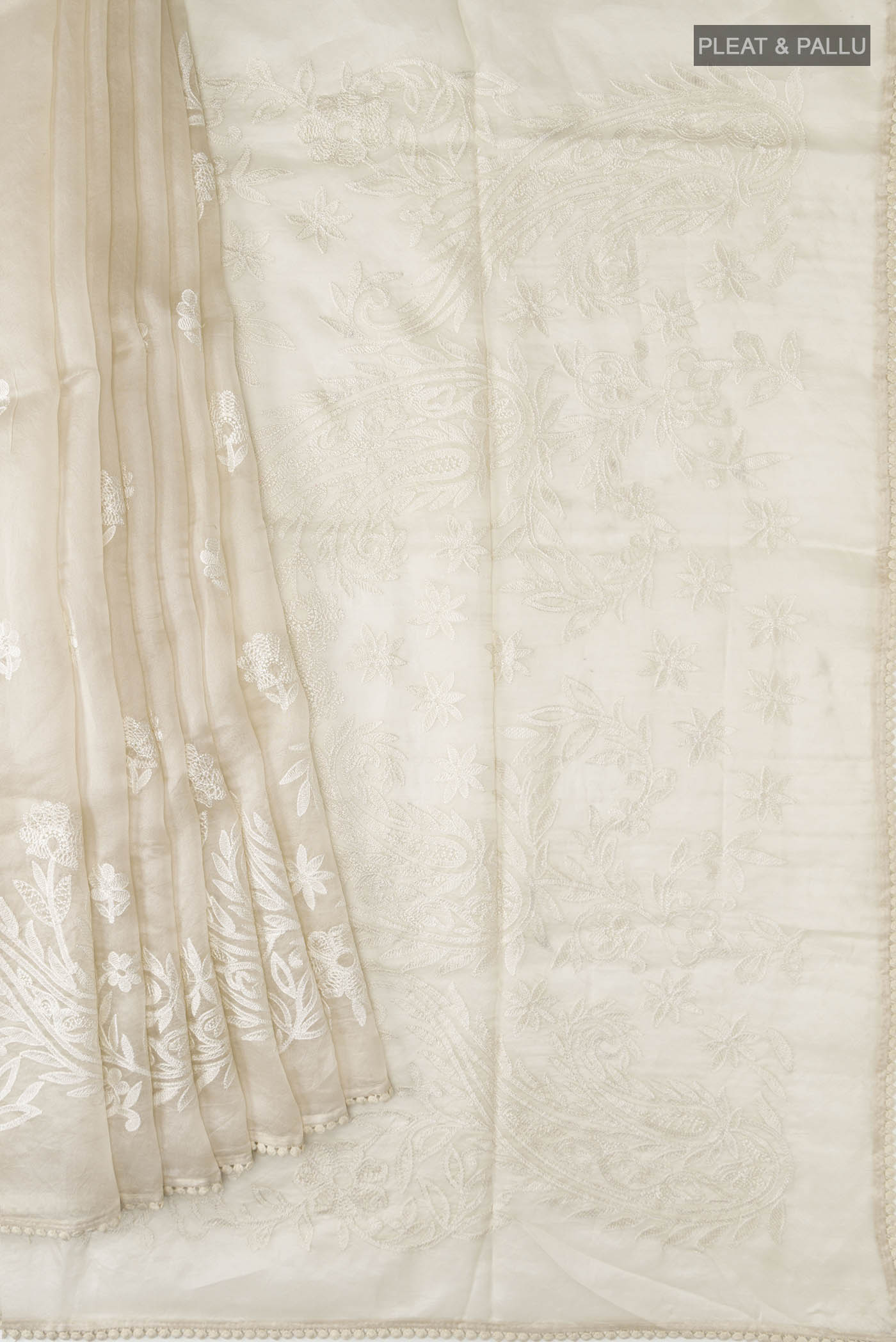 Pleats and pallu of Off White Organza Silk Saree with Embroidery on the body and Embroidery Border