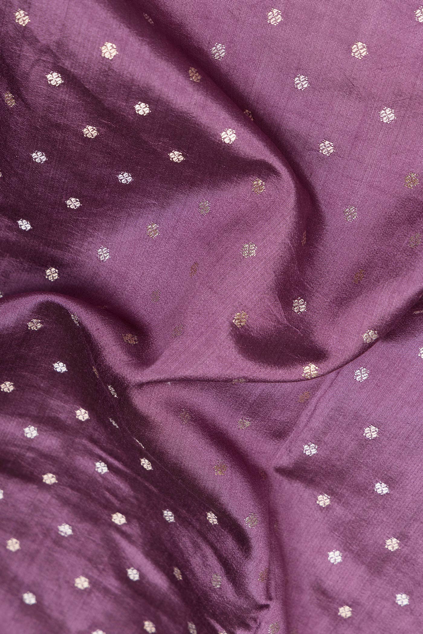Close up of Purple Dual Tone Tussar Silk Saree with Zari Butta on the body and Embroidery Border.  displaying folds