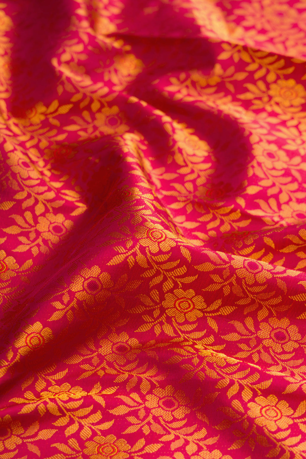 Close up of Pink Dual Tone Kanjivaram Silk Saree with Zari Brocade on the body and Zari Border.  displaying folds