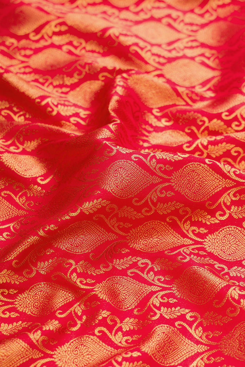 Close up of Red Dual Tone Kanchipuram Silk Saree with Zari Brocade on the body and Zari Border.  displaying folds
