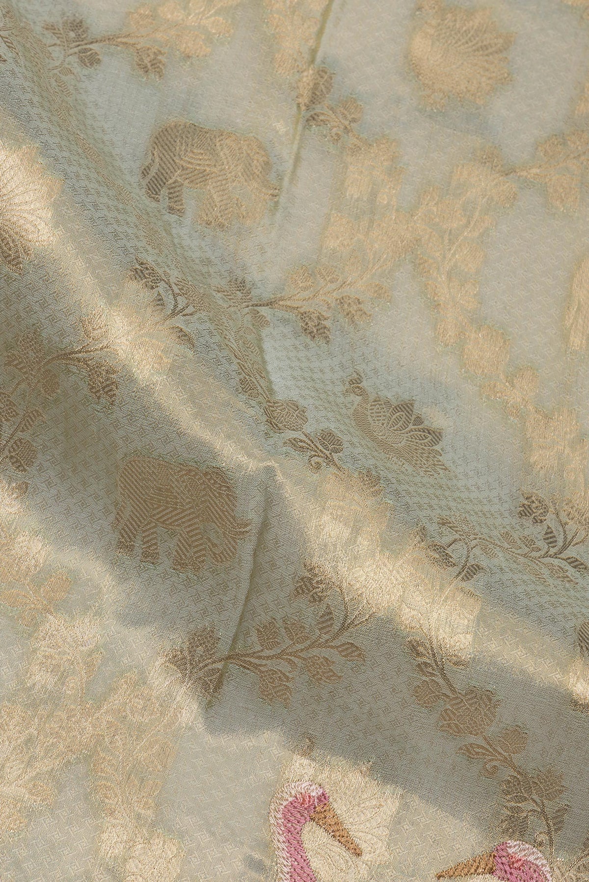Close up of Pista Green Blended Banarasi Silk Saree with Zari Brocade on the body and Fancy Border.  displaying folds
