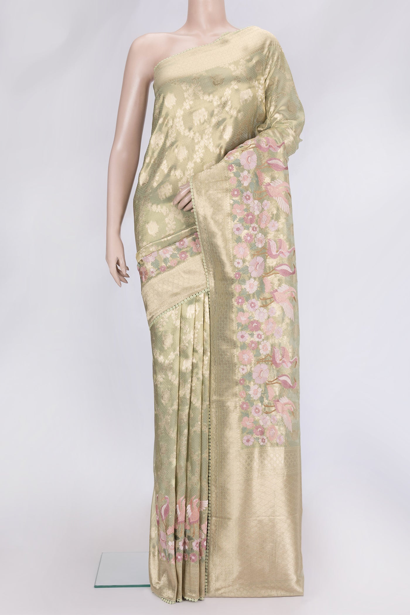 Pista Green Dual Tone Organza Silk Saree with Zari Brocade on the body and Embroidery Border.  displayed on a mannequin