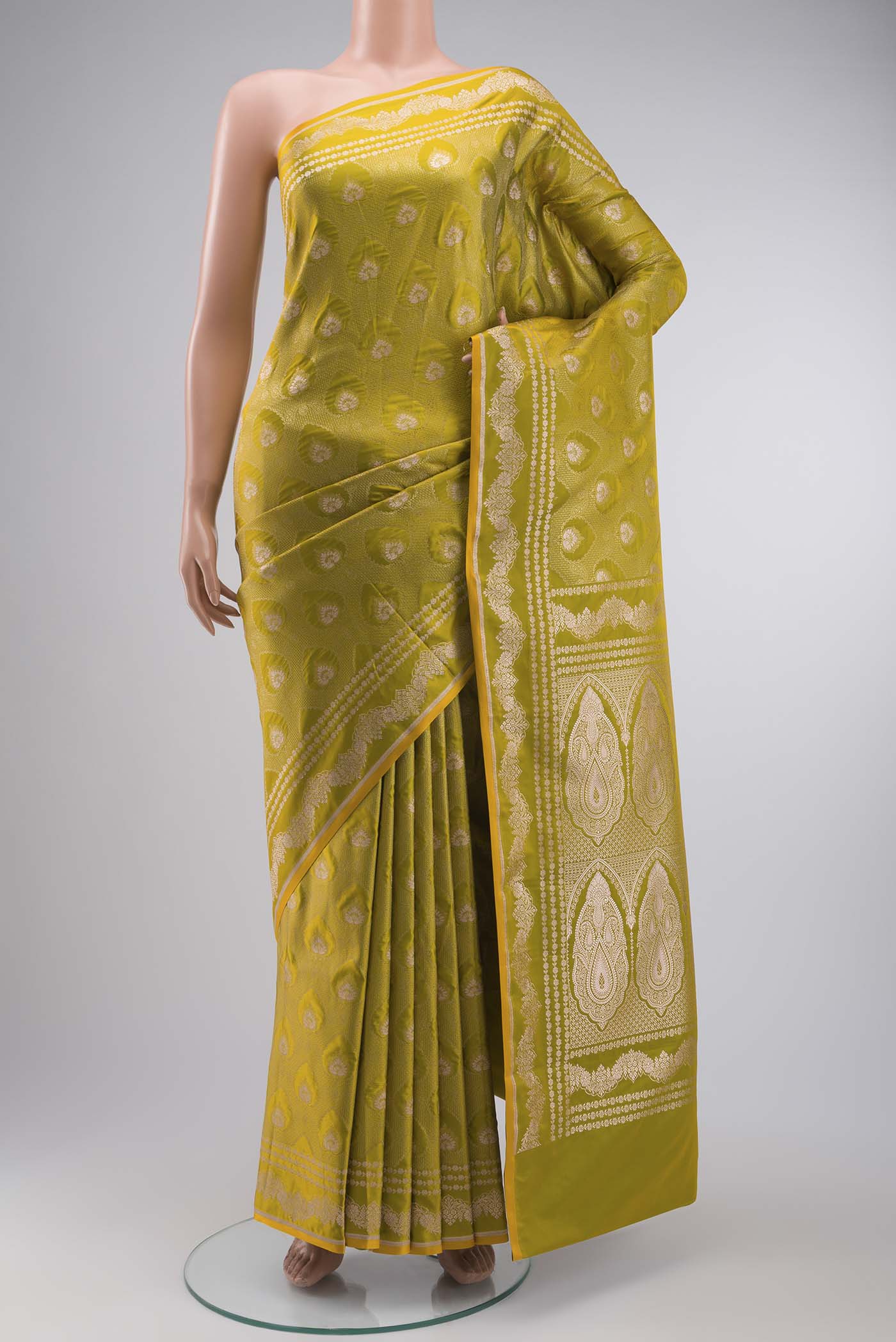 Green Blended Banarasi Silk Saree with Zari Butta on the body and Zari Border displayed on a mannequin