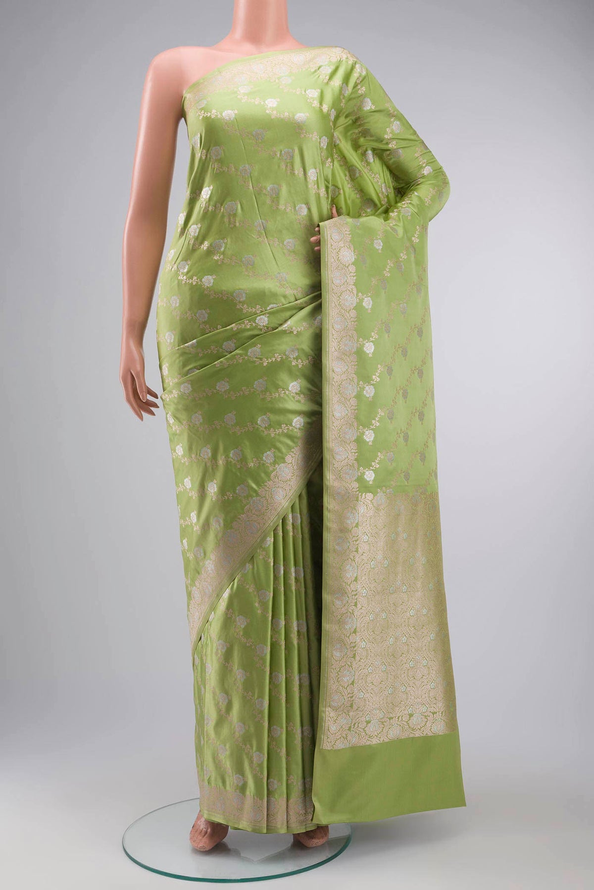 Green Blended Banarasi Silk Saree with Zari Butta on the body and Zari Border displayed on a mannequin