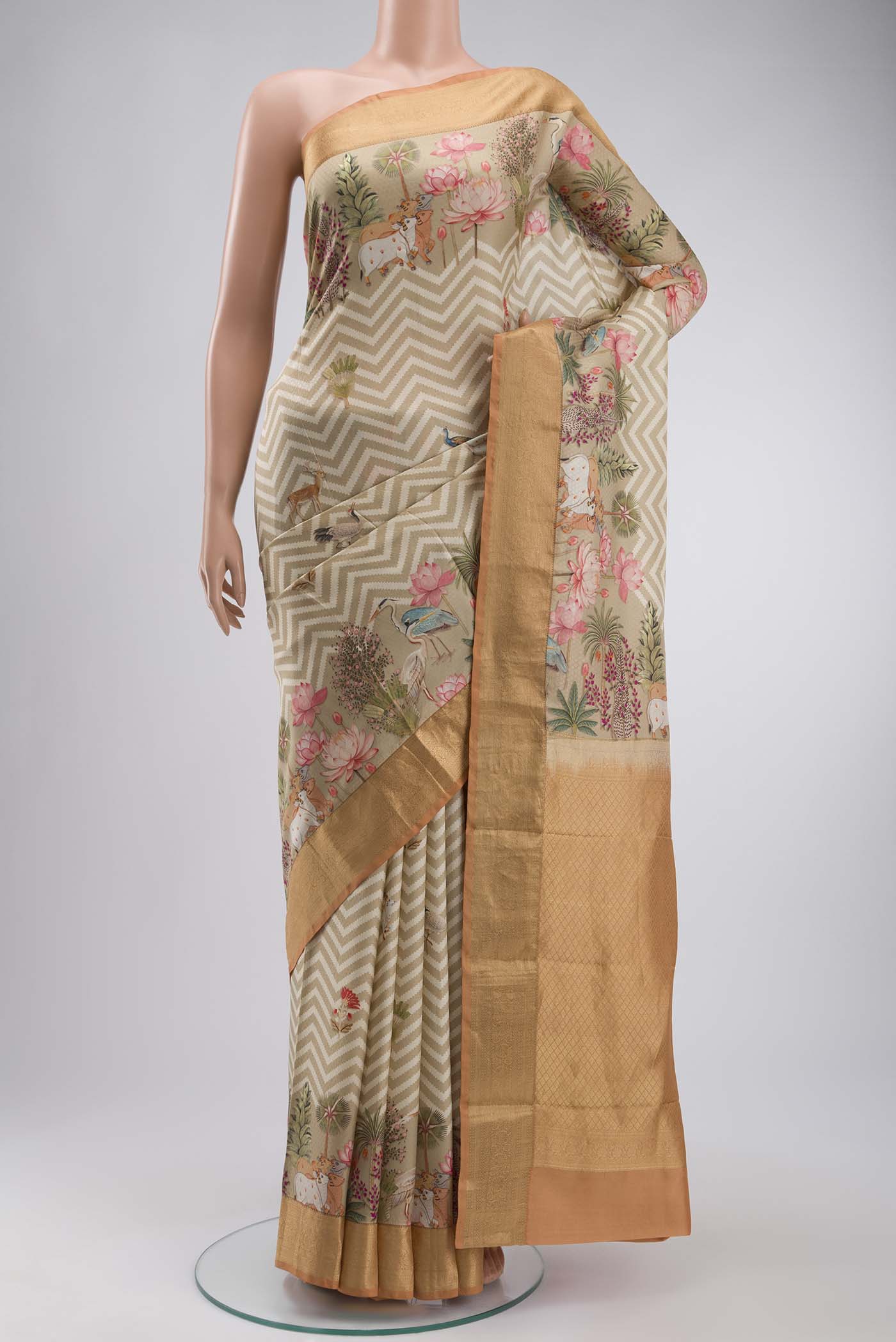 Beige Printed Silk Saree with Printed design on the body and Zari Border displayed on a mannequin