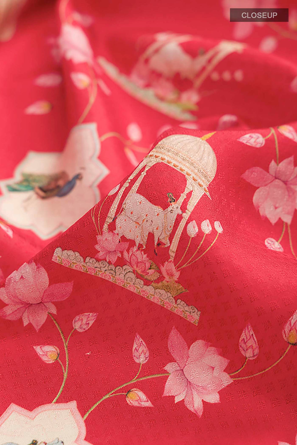 Close up of Red Printed Silk Saree with Printed design on the body and Zari Border displaying folds
