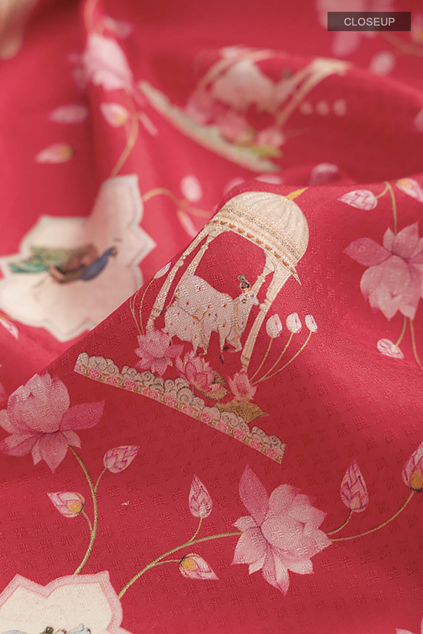 Close up of Red Printed Silk Saree with Printed design on the body and Zari Border displaying folds