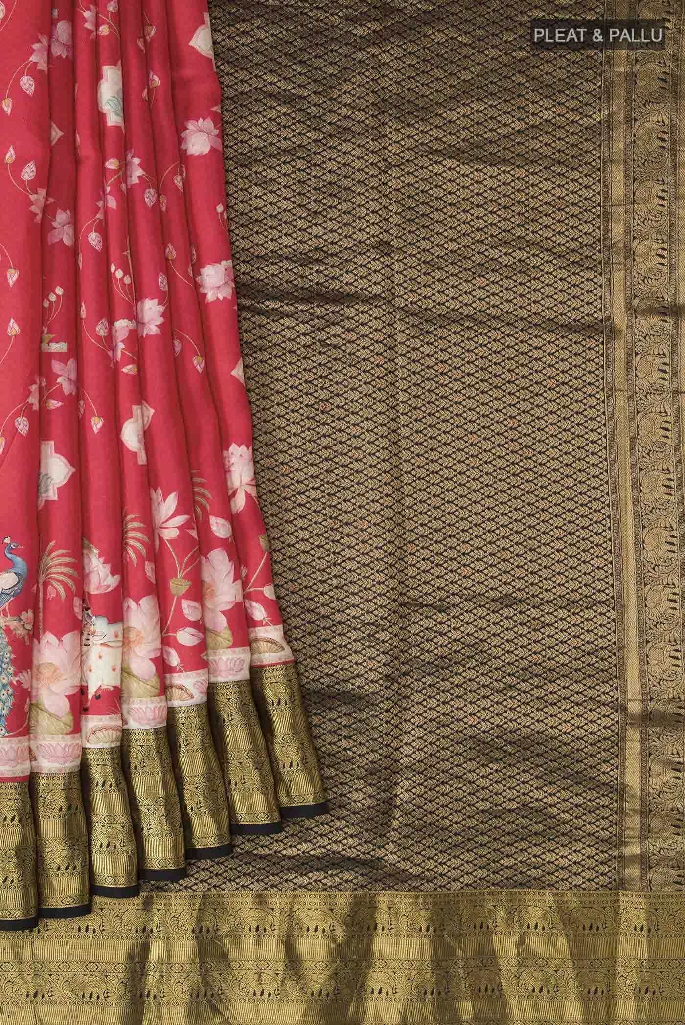 Pleats and pallu of Red Printed Silk Saree with Printed design on the body and Zari Border