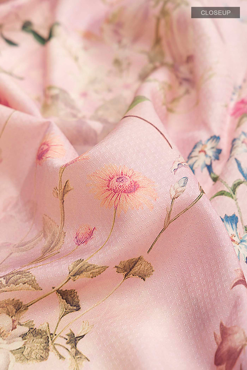 Close up of Rose pink Printed Silk Saree with Printed design on the body and Zari Border displaying folds