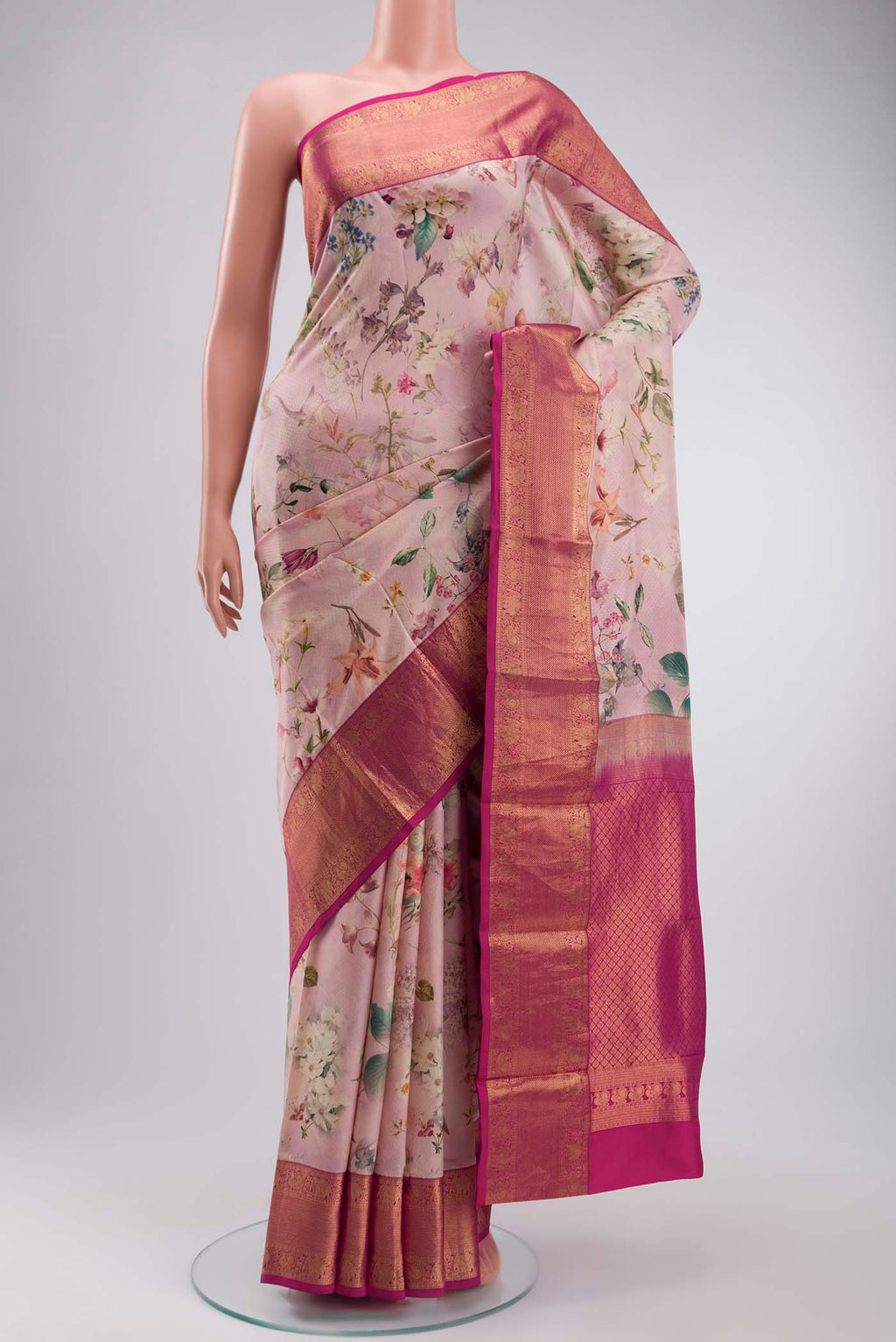 Rose pink Printed Silk Saree with Printed design on the body and Zari Border displayed on a mannequin
