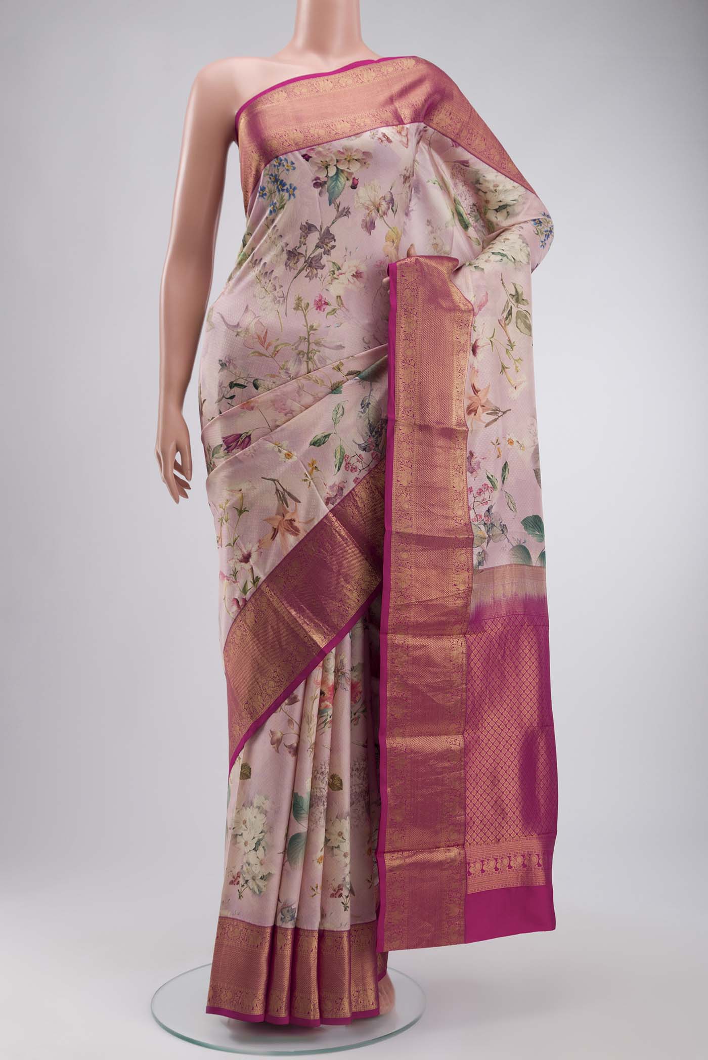 Rose pink Printed Silk Saree with Printed design on the body and Zari Border displayed on a mannequin